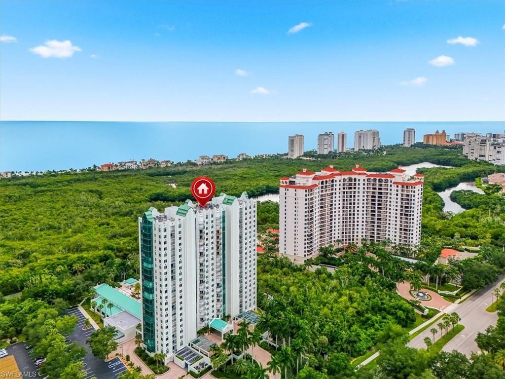 Experience the pinnacle of Naples luxury in this stunning 3-bedroom, 2.5-bathroom high-rise residence in the prestigious, guard-gated community of Pelican Bay. Situated in the highly sought-after Claridge building, this meticulously designed condo seamlessly blends sophisticated coastal style with world-class resort amenities. The expansive open layout features floor-to-ceiling windows that flood the living area with natural light, capturing golden sunrises over the golf course and vibrant sunsets over the Gulf of Mexico. The gourmet kitchen boasts premium finishes, custom cabinetry, and high-end stainless-steel appliances. A serene primary suite offers generous walk-in closets and a spa-like bath with dual vanities, a soaking tub, and an oversized shower. Two additional bedrooms provide flexibility for guests or a home office, complemented by a spacious private lanai to enjoy gentle Gulf breezes. The Claridge offers an intimate environment with just four residences per floor, featuring a resort-style pool, spa, fitness room with saunas, social room, guest suites, 24/7 front desk security, and secured under-building parking. Pelican Bay living grants exclusive access to private white-sand beaches via a scenic tram, beachfront dining at Marker 36 and the Sandbar, tennis, pickleball, and a community fitness center. Located minutes from Waterside Shops, Mercato, and Artis-Naples, this property delivers the ultimate luxury coastal lifestyle.