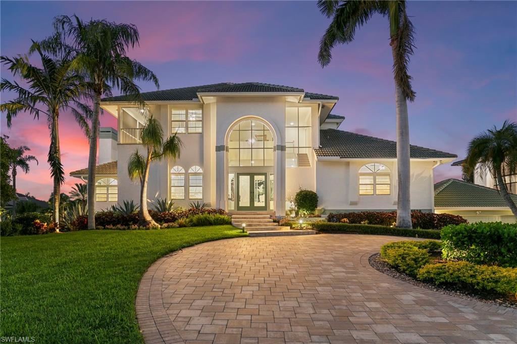 One or more photo(s) has been virtually staged, AI generated or rendered.  Luxury home in the exclusive Marco Island Estates surrounded my mansions. Home sits on a 1/2 acre estate lot with 125 feet of water frontage, and has been totally updated and ready for you to move in. This luxury home offers a 5 car garage, new concrete seawall, and new boat dock. Significant price reduction, now positioned as one of the best waterfront values on Marco Island, especially being located in the Estates with quick deep water direct access for under $3.5M! This is a must see property that offers an impressive custom diamond designed composite dock that spans across the entire 125 feet of water frontage. In addition, the boat dock features a 3 jet ski/kayak platform lift and a 10,000 lb. boat lift with a waterway canopy for safe protected harbor. Short distance to the Gulf, less than 500 feet to open water. This beautiful 4 bedroom and 4.5 Bath home offers a private elevator and is being offered furnished. In addition, each bedroom has it's own ensuite bathroom. This property has new impact doors, windows, and sliders (2024), new kitchen remodel (2022) that includes a new gas island cooktop, quartz countertops, custom cabinetry, new backsplash, double bowl enameled cast iron kitchen sink w/ a Kohler Artifacts pull down faucet, new ice maker, beverage and wine cooler, and a reverse osmosis drinking water system. Take in your mornings at the breakfast counter or relax in the family room with a rare coral faced fireplace with new remote controlled vented gas logs. There is an elegant formal dining area to entertain guests and a separate living room with media center. The impact sliding glass pocket doors lead to the main floor balcony to overlook the expansive screened-in lanai pool area and waterway. The primary suite has a spacious sitting area, newly installed remote controlled drop down television, new bathroom vanities, quartz countertops, new faucets, new luxury Eago Whirlpool Bath Spa, and a private screened-in balcony to sit and relax to take in the waterway views. Enjoy swimming and soaking up the sun as the pool recieves sunlight in the afternoons. Additional updates include two new A/C units (2023), new 1,000 gallon buried LP tank with WIFI monitoring, freshly painted exterior (2023), wood plantation shutters throughout, new closet doors, new landscape lighting, new salt water pool equipment (2022), Wi-Fi-enabled garage doors, security system, and the home is prepped for a generator. This property displays a luxurious circular brick paver driveway and travertine pavers throughout the lanai. Don't miss this opportunity to be in one the most premier locations on Marco Island. Make this your new home in paradise.