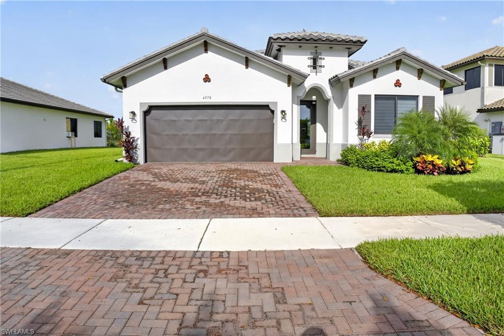 Welcome to this better than new Greenview model in the highly sought after Maple Ridge at Ave Maria! Built in 2023, this beautifully upgraded residence offers 3 spacious bedrooms plus a den, 2 full bathrooms, 1 half bathroom, and a 2 car garage, combining modern design with exceptional comfort and functionality.

From the moment you step inside, you'll appreciate the impressive upgrades throughout, including Level 5 tile flooring in the main living areas, Level 5 wall tile in both the primary and guest bathrooms, and Level 5 shower floor finishes that add a luxurious touch. The open-concept layout is enhanced by recessed lighting in the great room and primary bedroom, while impact resistant windows and doors provide peace of mind, energy efficiency, and storm protection.

Unlike new construction, this home is truly move-in ready with modern window blinds already installed and a spacious patio deck designed for entertaining, weekend BBQs, or simply relaxing with family and friends, in addition if you have an electric car, for your convenience a tesla charger is also installed in the garage.

Located at 4978 Jovanne Street, this home is nestled within the award winning Maple Ridge community, where residents enjoy a resort style lifestyle with outstanding amenities. The clubhouse features a spectacular resort style pool with bbq area, state of the art fitness center, exercise room, billiards room, card room, gathering and meeting rooms, and plenty of social spaces for year-round enjoyment. Best of all, you'll enjoy these amenities with low HOA fees.

Offering the perfect combination of luxury, value, and lifestyle, this home is an incredible opportunity at just $550,000. Homes with this level of upgrades and move-in-ready appeal don't stay on the market for long. Schedule your private showing today and experience everything this exceptional home and the vibrant Ave Maria community have to offer before it's gone!