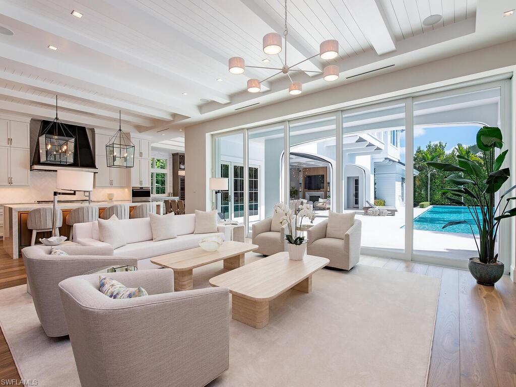 Fantastic opportunity to acquire this MHK Architecture designed, stunning home built by VIV. Situated on an oversized 100’ x 185’ homesite on iconic Gordon Drive, ideally close to Naples’ white-sand beaches and 3rd Street South. This 2023 coastal contemporary estate offers 7,384 square feet of air-conditioned living space with 5 bedrooms + study, 6 full and 2 half baths, upper lounge, VIP living area, and glass-enclosed exercise room. Exceptional finishes include Legno Bastone wide-plank flooring, Poliform closets, natural stone accents, designer fireplace, Lutron HomeWorks lighting and shade control, Sonos audio, elevator, and two laundries. Gourmet kitchen and separate service kitchen feature elite appliances, gas cooking, double ovens, steam oven, and built-in ice maker. Additional features include air-conditioned 4.5-car garage with EV charging, whole-house generator, impact-rated doors and windows, and full concrete construction. Expansive outdoor living area showcases a 65’ resort-style pool with swim-up bar, gas-heated spa, outdoor kitchen with island, fireplace, fire pit, and automated roll-down screens and shutters. Offered furnished and built for the ultimate luxury lifestyle.