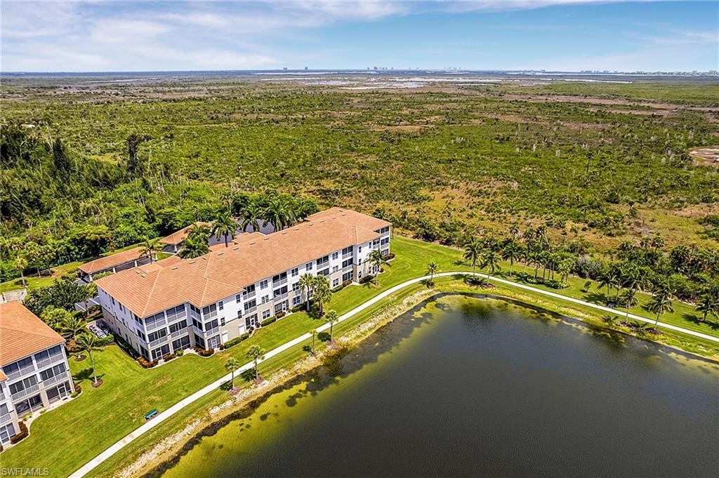 Welcome to this third-floor Sutton Walk Lakeside Condo in Lexington Country Club's Lake Village, ideally located at the rear of the community for exceptional privacy and one of the most beautiful lake views in Lexington. Enjoy breathtaking sunsets over the expansive lake with the Estero Preserve in the distance, providing a protected natural backdrop that will remain unchanged. This furnished, two-bedroom, two-bath condominium offers an excellent opportunity as a seasonal retreat, investment property, or full-time residence. Priced to allow you to update and personalize to your own style while enjoying the incredible location from day one. Inside, a screened entry welcomes you into a bright floor plan featuring tile flooring in the entry, kitchen, bathrooms, and wet areas, with carpet in the living room and both bedrooms. The spacious primary suite features sliding glass doors to the lanai, a window overlooking the spectacular lake and sunset views, dual vanities, and a walk-in shower with tile surround. The guest bedroom is furnished with two twin beds, while the guest bath includes a convenient tub and shower combination. If you've been searching for a condominium with outstanding views, privacy, and tremendous potential, this Lake Village residence is ready for your personal touch. Enjoy the Southwest Florida lifestyle with resort-style amenities, beautifully maintained grounds, and convenient access to beaches, shopping, dining, entertainment. Just across the street from Health Park.
