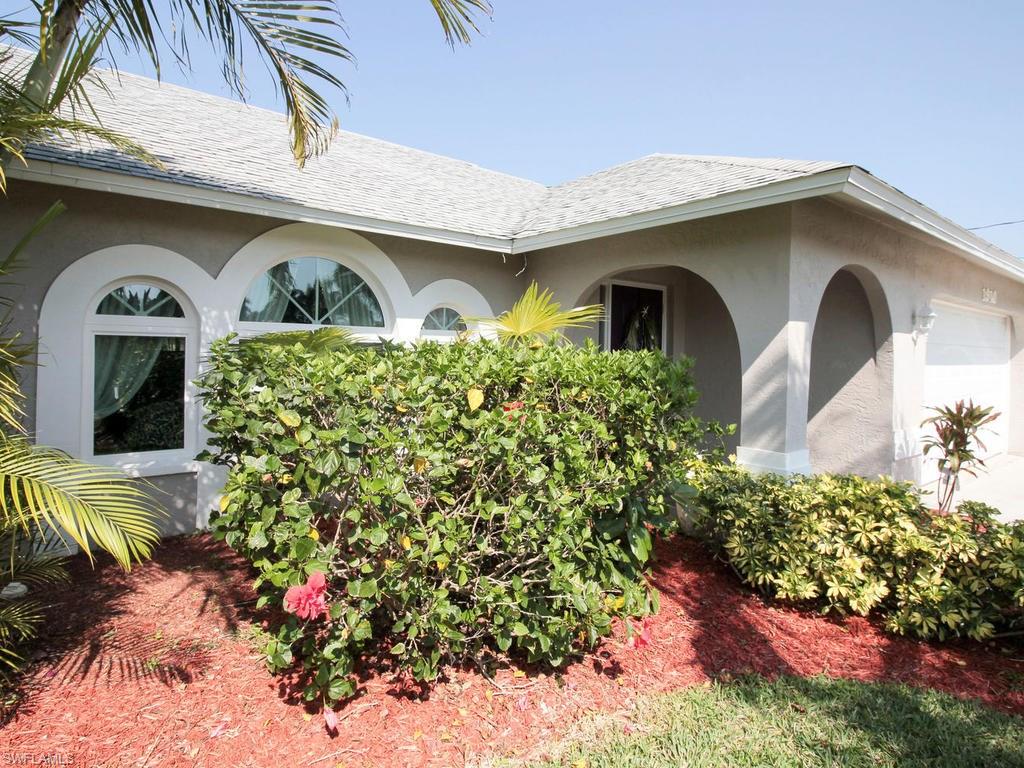 Great Location on the desirable 200' wide Rubicon canal. Updated 3/2 with large ACd 2 car garage. Stunning kitchen with cherry cabinets, pull out shelves, granite counters and stainless appliances. Open floor plan with split bedrooms. Each bedroom has a walk-in closet providing lots of storage. Tile thru out. Large laundry room with even more storage. Extra deep lot provides ample room for a pool. Dock with 10000 lb boat lift. No road noise here! One bridge to river. Bonus -No flood insurance required. Impact glass slider and living room windows. Well maintained home - move in ready. Call today for your showing. The home was been replumbed.