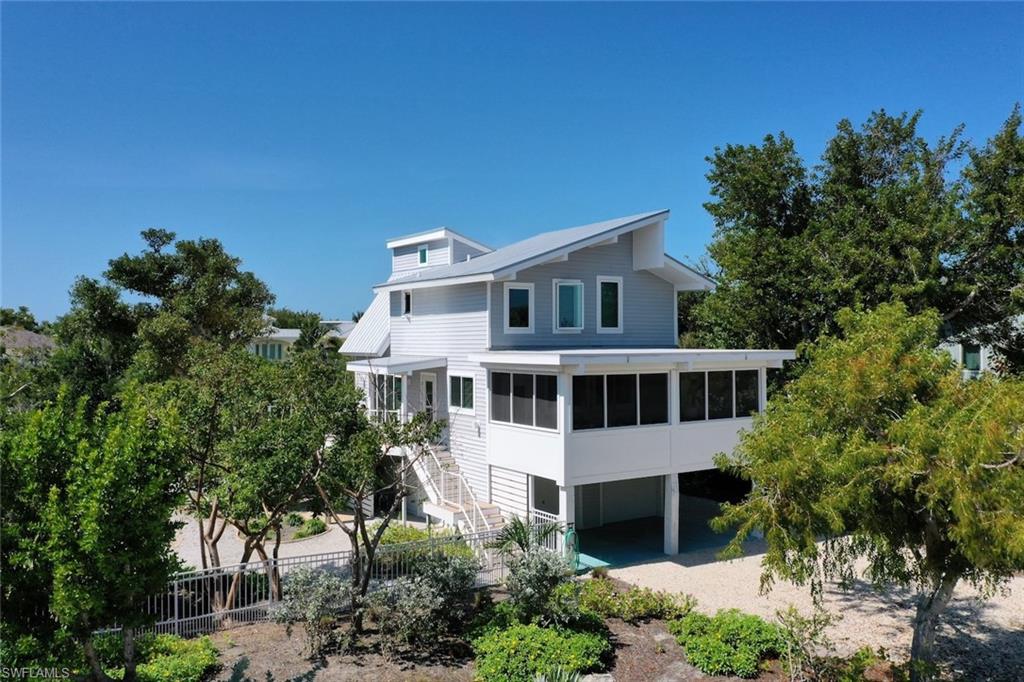 Step into coastal luxury with this exceptional direct-access canal home in the highly sought-after Del Sega community on Sanibel Island. Perfectly positioned for both privacy and breathtaking water views, this elevated residence has been completely reimagined with a full top-to-bottom renovation—offering a seamless blend of modern elegance and relaxed island living.
From the moment you enter, you’re greeted by soaring ceilings, abundant natural light, and an airy, open-concept design that invites the outdoors in. The stunning kitchen is a true centerpiece, featuring sleek gloss cabinetry, sophisticated grey quartz countertops, and premium stainless-steel appliances—perfect for both entertaining and everyday living. The adjoining dining area flows effortlessly onto an expansive deck, where long canal views create a picturesque backdrop for morning coffee or sunset cocktails.
Enjoy the best of Southwest Florida’s wildlife right from your backyard—watch dolphins glide by, manatees surface, and herons wade gracefully along the water’s edge. Just off the living room, a spacious screened porch offers the ideal setting for year-round outdoor dining or simply unwinding while surrounded by tropical breezes and lush greenery.
Upstairs, the home continues to impress with three beautifully updated bedrooms and two full baths, each designed with comfort and style in mind. Every detail has been thoughtfully considered, including major upgrades such as a newer roof, air conditioning system, water heater, Trex decking, and a private dock—providing direct gulf access to open waters with ease.
Whether you’re seeking a serene full-time residence, a seasonal retreat, or an investment in paradise, this move-in-ready home truly has it all. Experience the ultimate Sanibel Island lifestyle—schedule your private showing today.