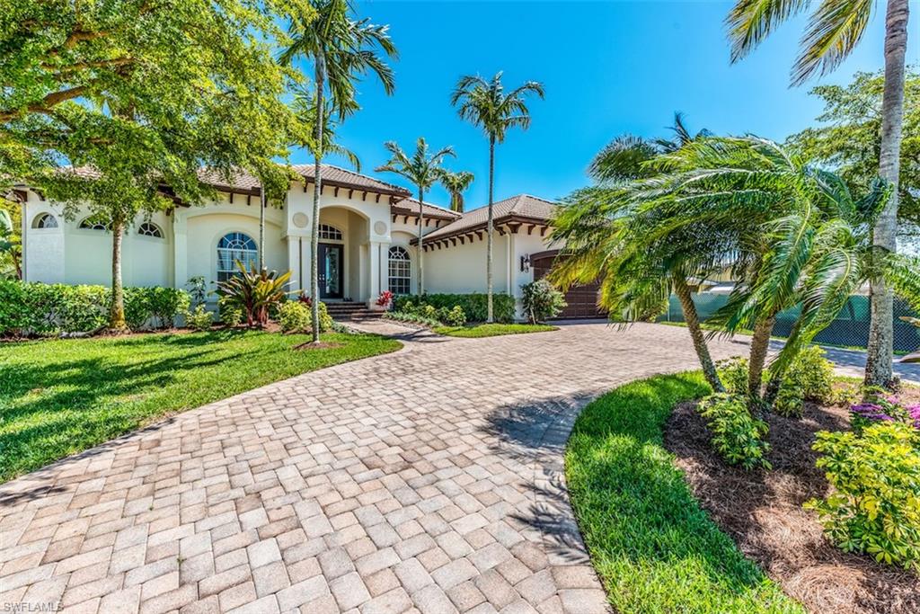 DIRECT GULF ACCESS FROM CLASSICALLY BEAUTIFUL HOME ALL ON ONE LEVEL WITH OVER 3000 SQ FT UNDER AIR. THREE BEDROOM SUITES, HALF BATH, PLUS A DEN/OFFICE FEATURING OAK FLOORS AND WOODEN CEILING DETAIL. MANY UPGRADES INCLUDING GRANITE KITCHEN AND BATHS, GORGEOUS POOL AND SPA, & SUMMER KITCHEN FOR OUTDOOR GRILLING AND ENTERTAINING. SOARING 12 FT CEILINGS WITH DETAILED ARCHITECTURAL EFFECTS. OPEN FLOOR PLAN WITH EAT IN KITCHEN AND BREAKFAST BAR. DESIGNER TILE THROUGHOUT LIVING AREAS. NEW PLUSH CARPET IN ALL BEDROOMS. FRESHLY PAINTED INSIDE AND OUT. BOATING IS A DREAM IN THIS LOCATION AS HOME SITS AT INTERSECTING CANALS. LOVELY WATER VISTAS FRAMED WITH TROPICAL FLORA. THIS HOME IS A TRUE VALUE AND OFFERS THE BEST OF FLORIDA LIVING IN A RAPIDLY APPRECIATING AREA CLOSE TO OLDE NAPLES BEACHES, DINING, AND ENTERTAINMENT.