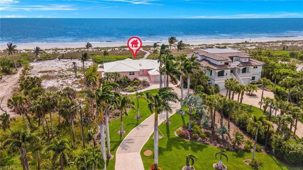 Experience the epitome of island living with this stunning Sanibel beachfront home!  Meticulously renovated to accentuate space and capture the essence of Sanibel's beauty, this architectural masterpiece offers unparalleled luxury.  Savor awe-inspiring  180-degree views of the Gulf of Mexico from your own Gulf Front retreat, a location that's truly one-of-a-kind.

Every detail of this home has been thoughtfully designed, with no expense spared. From the brand-new HVAC, electric, and plumbing to the impact skylights and windows/doors, every aspect exudes quality and craftsmanship. Step inside to discover luxury vinyl wood-like floating floors,  designer tiles,  and an enviable kitchen featuring top-of-the-line Thermador appliances, custom cabinetry, and designer wallpapers.

With four bedrooms, four baths, and two laundry areas, this home offers ample space for family and guests. Enjoy cozy evenings by the electric fireplace or entertain in style in the open gallery living area, where a Nana-wall seamlessly connects indoor and outdoor living spaces. Professionally designed landscaping by Coastal Vista surrounds the property, creating a serene oasis just steps from the private beach path.

Additional features include a double-car garage and upscale finishes throughout. Sold fully furnished with beautifully appointed pieces from Sanibel Home Furnishings, this home is truly a premiere showcase of island living.  Seize the opportunity to immerse yourself in unparalleled luxury and serenity – schedule your private viewing today!