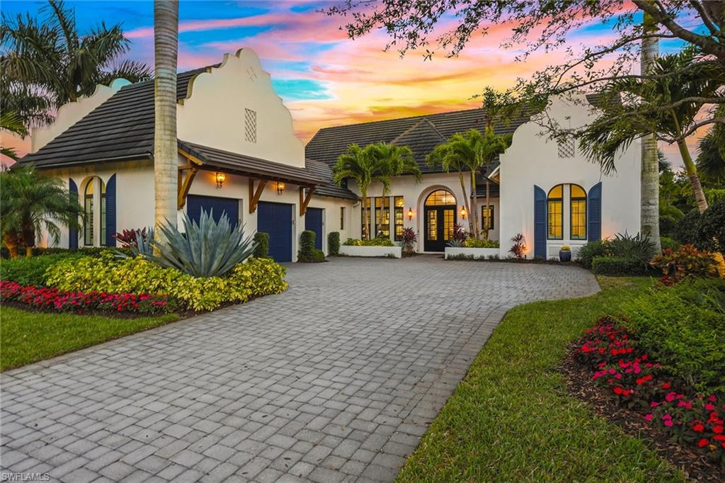 Surrounded by lush tropical landscaping on a nearly half-acre home site, this stunning designer-furnished residence in the desirable Marsh Cove village of Fiddler’s Creek offers exceptional privacy, desired southern exposure and luxury indoor-outdoor living at its finest. Built in 2018 and showcasing the sought-after Pontevedra open floor plan, the home offers four bedrooms plus a den, five baths and nearly 3,600 square feet of thoughtfully designed living space, complemented by a spacious three-car garage and expansive outdoor living areas. From the moment you enter through metal and glass French doors with a transom window, refined finishes and architectural details set the tone, including wood-look porcelain plank tile flooring throughout, volume and vaulted ceilings, recessed LED lighting and plantation shutters. Designed to capture natural light and seamless flow to the outdoors, the main living areas open to a spectacular private lanai retreat framed by mature tropical landscaping and a large backyard. The outdoor living area features natural stone pavers, a heated pool and spa with spillover, decorative fire bowls and fountain, and a picture-frame pool cage maximizing tranquil garden views. Two covered lanai spaces provide inviting areas for relaxing or entertaining and are enhanced by a gas fireplace and lighted pool cage columns, while the summer kitchen includes a stainless gas grill, cooktop and under-counter refrigerator. Additional outdoor features include a poolside bath, electric storm shutters enclosing both lanai areas, and with impact glass throughout. The chef’s kitchen is beautifully appointed with quartz counters, natural stone tile backsplash, center island, white cabinetry with under-cabinet lighting and pullout pantry shelving, and premium appliances including a six-burner natural gas range with griddle. The dining area features custom built-in cabinetry with accent lighting and views of the pool and lanai, while the spacious living area offers a built-in entertainment center, dry bar with under-counter wine refrigerator and sliding glass doors opening to the outdoor living space. The private primary suite includes a sitting area, plantation shutters and direct lanai access, while the luxurious bath offers dual quartz vanities, a freestanding soaking tub, frameless glass walk-in shower with dual shower heads and a large custom walk-in closet. Guest accommodations include two bedrooms connected by a Jack-and-Jill bath and a separate guest suite with en-suite bath and walk-in closet, while the den with built-in desks and cabinetry provides an ideal home office. Additional highlights include a custom wine bar with two wine refrigerators, tankless water heater and a three-car garage with epoxy flooring and built-in storage. Residents enjoy Fiddler’s Creek’s resort-style amenities including pools, dining, tennis, fitness, pickleball and spa services with optional memberships available for golf, marina and beach club access.