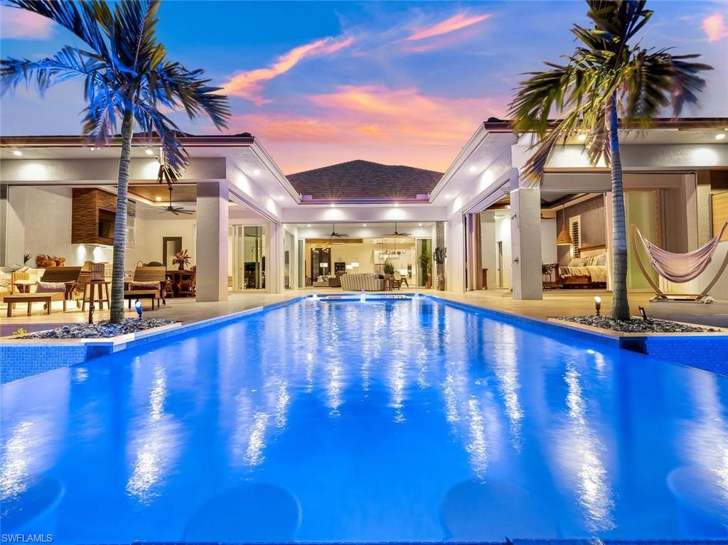 Embrace the epitome of Opulent Waterfront Living at this breathtaking Riverfront Luxury Estate! Completed in 2022, this residence boasts an unrivaled fusion of modern comfort & serene natural beauty! As you step inside the 12’ iron doors, you're greeted by a sprawling interior exuding a sense of refined grace. Expansive 10' pocket door sliders invite panoramic views of the glistening river & skyline, creating a seamless blend between indoor & breathtaking outdoors. With 3 en-suites for privacy & convenience, nearly every room in this home provides stunning river views, including the Master with 90-degree corner pocket doors.
A masterpiece designed for both relaxation & entertainment, the outdoor oasis beckons with its sprawling terrace, infinity-edge pool, spa overlooking the tranquil waters, cabana, & not one, but TWO boat docks! The property is an architectural marvel adorned w/meticulous attention to detail & luxurious finishes including Shell Stone flooring throughout, Amish White Oak cabinets, Cambria Quartz, a colossal 33' deep, 30' wide garage & much more! This location ensures exclusivity while maintaining close proximity to upscale dining, shopping, & entertainment!