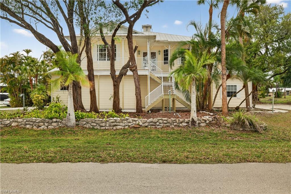 Live the active aviation lifestyle in this 3 bdrm plus den/3bath Key West–style home with private hangar located in Buckingham Airpark. This desirable, non-gated airpark community offers low HOA fees and direct access to FL59 runway, a lighted 4,500’ x 400’ concrete runway. Built in 1997, this 1,822 sq ft residence captures nostalgic Old Florida charm complete with native landscaping, while offering functional, open-concept living ideal for everyday comfort and entertaining. Warm real wood flooring and abundant natural light welcome you into the spacious great room, which flows seamlessly into the kitchen featuring generous cabinetry and ample counter space. The open, airy living space extends to a large screened rear porch where privacy and tranquility create the perfect setting for morning coffee or evening relaxation. The primary suite is separated from the guest bedrooms and offers access to the rear screened in porch. A spacious ensuite bath with a walk in shower, dual vanities and a walk in closet complete the primary suite. There is a flexible bedroom/den which is ideal for a home office, nursery, or fitness room opposite the ensuite bath. A third upstairs bedroom, privately situated behind the kitchen with its own full bath, provides comfortable accommodations for guests. The lower level is designed with both lifestyle and functionality in mind. Your private aircraft hangar offers 1350 sq ft of space with abundant storage cabinets. The bi-fold door measures 40'x9'4". There is a separate oversized two car garage located opposite the hangar space. This level also includes an additional large bedroom with private entrance, a full bath, and laundry room—ideal for guests, extended family, or multi-generational living. A beautiful wood staircase connects the levels, leading back to the bright and expansive upstairs living area. The airpark location is close to I-75, giving you easy access to shopping, dining, entertainment and of course our wonderful beaches! The historic riverfront downtown is only 20 minutes away. Virtual link above will provide 3D walk through, floor plan and room dimensions. Agents please see confidential remarks.
