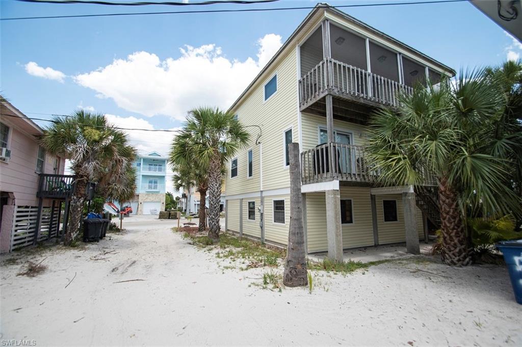 Own your own RARE piece of paradise on the highly coveted area known as Island Shores of Fort Myers Beach. A true beach house as you are just a few meters away from 7 miles of white sandy beachfront.  Drive in to your private under building garage with plenty of room for storage. Around the back of the home are the stairs to one of two decks.  The upper deck has a wonderful view of the Gulf of Mexico. Enter through front door to 1st level open floor plan. Kitchen, living area bedroom and bath and sliders to the deck. Upstairs you find two more large bedrooms and a bath. The primary bedroom has sliders to an upper level screened in deck. The beach is just 150 feet to 7 miles of powder white sandy beach. Great investment for a weekly rental vacation home. Tropical landscape adds to the charm of the location. You are less than .25 mile to Times Square, the Fort Myers Beach Pier, shops, restaurants with easy on/off island access and future home of Margaritaville Resort. Contact your agent for showings on Saturdays 1-2:30 or Wednesdays 1-4
