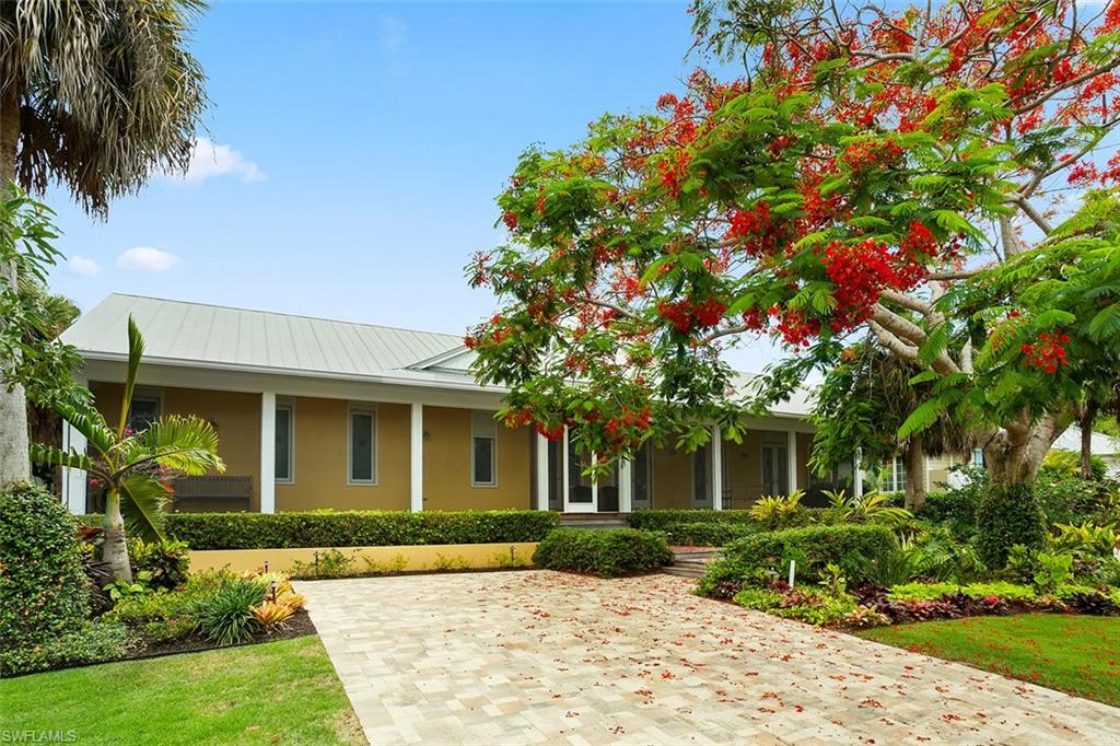 World class Aqualane location! Just 2.5 blocks to the beach, great walkability less than a block to the fine dining and shopping of the 3rd street district. Situated on a large, Western exposure parcel with alley access to 2.5 car garage. This charming home is in impeccable condition. State of the art chef's kitchen, incredible outdoor living and pool area. Large screened in pool/patio. Beautiful grounds featuring a majestic royal poinciana at entry that highlights an immaculately manicured front walk. A great old Naples beach cottage feel.