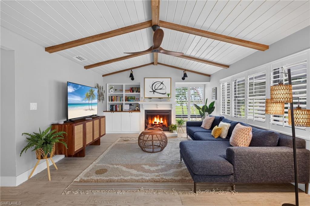 Thoughtfully reimagined following an extensive $200,000 renovation, this exceptional residence in Sanibel Island's desired Beachview community blends sophisticated design with one of the island's most desirable lifestyles. Influenced by mid-century architecture, the home showcases clean lines, rich textures, and curated finishes that feel timeless and fresh. A dramatic vaulted ceiling with exposed beams and warm wood inlays anchors the main living spaces, while wood-look tile flooring and a striking fireplace create an atmosphere of understated elegance. At the heart of the home, the beautifully redesigned kitchen serves as a design statement and culinary centerpiece. Custom thin-shaker cabinetry, an extra-thick quartz slab countertop, beverage bar with sink and refrigerator, JennAir built-in refrigerator/freezer, a JennAir microwave, Meile dishwasher and a stunning 48-inch AGA induction range from England elevate the space beyond the ordinary. Walls of glass frame sweeping views across multiple golf holes and sparkling lakes, creating a backdrop that changes beautifully throughout the day. The connection between indoors and out is enhanced by an elevated pool and outdoor living area designed to flow seamlessly from the home's main gathering spaces. This rare configuration improves accessibility and livability, transforming the outdoor environment into an extension of the home. The primary suite offers a private retreat with two walk-in closets and a spacious bath featuring a jetted soaking tub, separate walk-in shower and dual-sink vanity. Guest accommodations are equally thoughtful, including one bedroom with a custom Murphy bed and another with a walk-in closet featuring custom built-ins. A renovated guest bath showcases a beautiful walk-in shower and double-sink vanity. Additional features include custom wood-grain garage doors, front-load washer and dryer, utility sink and numerous upgrades throughout. On an elevated homesite with the home and pool thoughtfully raised, the property demonstrated exceptional resilience during Hurricane Milton, according to the owner, with water never reaching the pool. Beyond the home itself, Beachview offers an exceptional island lifestyle. Residents enjoy deeded beach access with private parking, making trips to the Gulf effortless. Several beachfront resorts with dining options are within an accessible and biking distance, while the community's semi-private golf club offers golf, recreation and dining amid beautiful natural surroundings. Surrounded by golf and lake vistas yet just moments from the beach, this residence captures a rare balance of coastal living, thoughtful design and everyday convenience, an exceptional opportunity to experience the best of Sanibel Island.