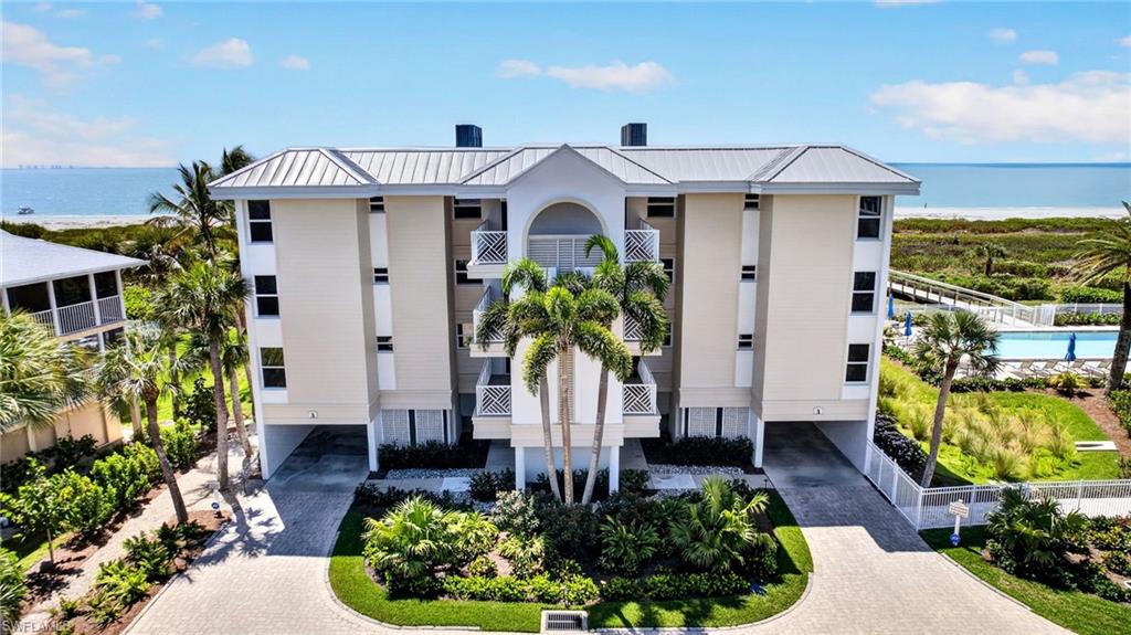 Wake up each day to sweeping, unobstructed views of the Gulf from this beautifully positioned east end island condominium, where endless blue water and breathtaking sunset skies become part of your everyday life. Expansive windows and sliders, recently upgraded to impact glass, frame the coastline from nearly every room and fill the interior with natural light and the soothing backdrop of the sea.

The spacious open living and dining areas flow seamlessly to a large, enclosed lanai, creating the perfect setting to relax, entertain, or simply take in the ever-changing Gulf views. Whether enjoying morning coffee with gentle waves in the distance or evening cocktails as the sun dips below the horizon, this home captures the essence of coastal living.

The kitchen is both functional and inviting, featuring granite countertops, ample cabinetry, and a layout that connects effortlessly to the main living space. Granite surfaces continue into the bathrooms, adding a cohesive and timeless finish throughout. The generously sized primary suite offers comfort and privacy, while the guest bedroom and an enclosed den with doors and a window provide flexible space currently utilized as a third sleeping area, ideal for accommodating additional guests or creating a private office or retreat.

Offered furnished, this residence is move-in ready and ideal as a personal retreat or investment opportunity. Additional features include exterior storage and convenient under-building parking.

Residents enjoy a well-appointed community with elevator access, direct beach access, a pool, and tennis and pickleball courts, everything needed to embrace the relaxed island lifestyle. Located on the desirable east end of the island, this property offers a quieter, more relaxed setting while still being just moments from local dining and shopping. Its convenient location near the Causeway allows for easy on and off island access, making trips to the mainland simple while still enjoying everything island living has to offer. The association allows for 30-day minimum rentals, providing flexibility for both personal use and income potential.