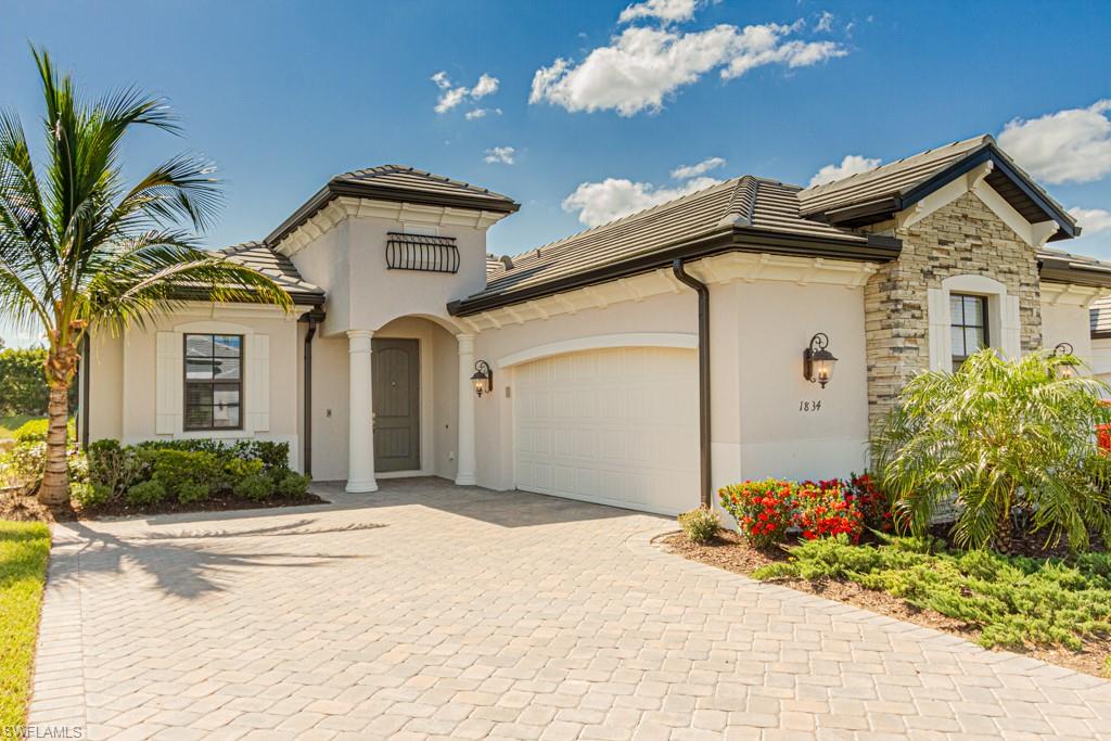 Wonderful opportunity to own an immaculate pool home with serene lake views in the desirable gated community of LaMorada in North Naples. Meticulously maintained, this 2 bedroom + spacious den / 2.5 bath move-in ready home lives large, featuring high ceilings and an open floor plan. Upgrades include wood-like tile throughout the living spaces and top of the line Coretec wide plank oak-look floors in the bedrooms. The king-sized master suite features a tray ceiling, two closets and an ensuite bathroom with dual vanities, a soaking tub, and a walk-in shower. The white kitchen features GE Profile appliances, including a GAS COOKTOP, smart oven, and a Keurig-maker built into the refrigerator. The large quartz kitchen island seats 6 and is perfect for entertaining guests. Enjoy the Florida lifestyle from your private lanai, complete with a built-in outdoor kitchen, heated pool and spa, convenient 1/2 bath and generous covered space. LaMorada offers residents a resort-style pool/spa, tennis/pickleball courts, a movie theater, a poolside bar/grill, social events and much more. All of this in an A+ rated school zone!