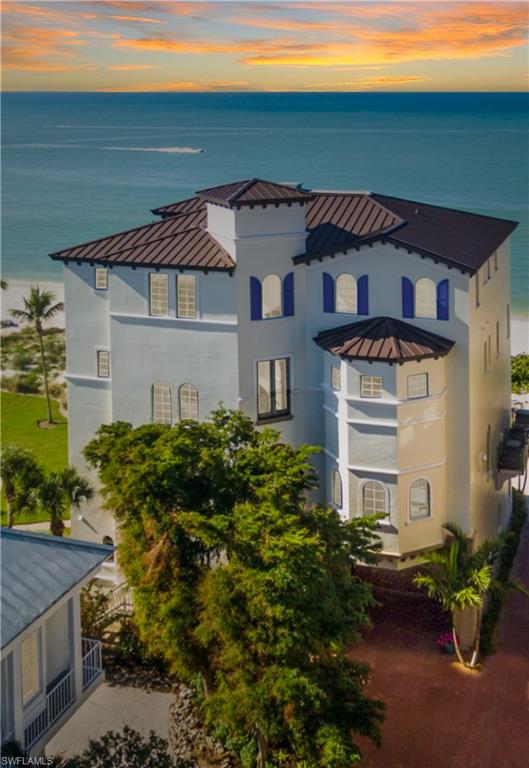 Direct beachfront, RARE 1st position, contemporary masterpiece with jaw-dropping Gulf view. Finest home available in North Naples with the Gulf of Mexico as the backdrop. Nestled in Collier County’s gated Barefoot Beach community, this 2008-built home radiates sophistication & will impress the most discerning eye. Open floor plan with 5 bedrooms & den, 2 lounges, movie theater with 106” projector & beachfront lanais on each level. Gulf view showcased by floor to ceiling picture windows. Incredible 400 sq ft chef’s kitchen with Viking, SubZero, Miele & Dacor professional appliances including double fridges, double ovens, 25-bottle wine cooler, built-in cappuccino maker & more. No details left undone, with marble, hardwood & new white oak floors, fiber optic enhanced ceilings, handblown chandeliers, illuminated waterfall, automated screens/shutters, hurricane impact glass, Crestron home automation with surround sound, smart light control & more. Updated in 2016 with new furnishings throughout & complete exterior renovation with new Corbels, new decorative shutters & new paint inside & out. Steps to beachfront pool & Club at Barefoot. Minutes to Mercato, Promenade & Waterside Shops.
