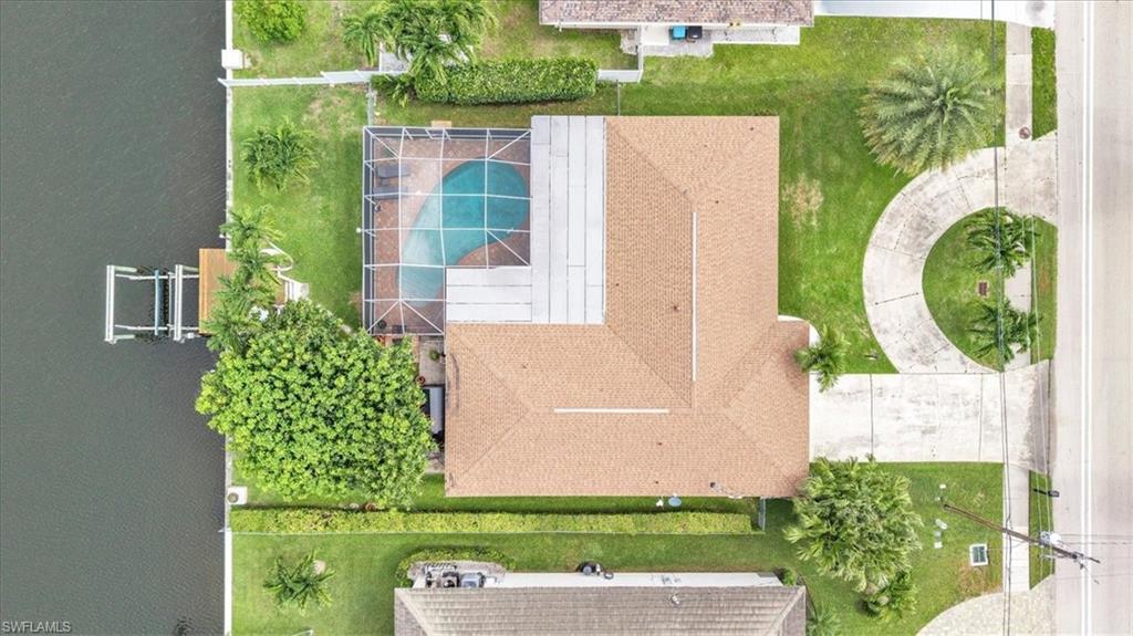 SAILBOAT ACCESS POOL HOME LOCATED ON PELICAN BLVD. Discover waterfront luxury in this stunning 4-bedroom, 3-Full bathroom sailboat-access pool home, perfectly situated in the prestigious Pelican Blvd area of South West Cape Coral. Home has been lovingly cared for by the same owners for over 25 years. Kitchen and bathrooms have all been remodeled within the past 3 years. Under truss lanai has tongue and grove ceiling and is HUGE with lots of room for entertaining. Third bathroom has an exit door to the garage, making it a perfect set up for multi-generational living. Or turn it into a vacation rental -- with FOUR bedrooms the income could be amazing. Circular driveway makes for easy in and out. Newer windows. This location offers premium boating access and convenient access to shopping, dining and entertainment as its just a short boat ride to Tarpon Point! Be sure to check out nearby Rotary Park for the stunning Butterfly Garden, Children's playground, Dog Park, mangrove boardwalk and more - all within walking distance! You deserve everything that SWFL has to offer. Enjoy the weather, boating, kayaking, jet skiing, world class fishing and white sandy beaches year round! BONUS: Giant Mango tree in backyard!!