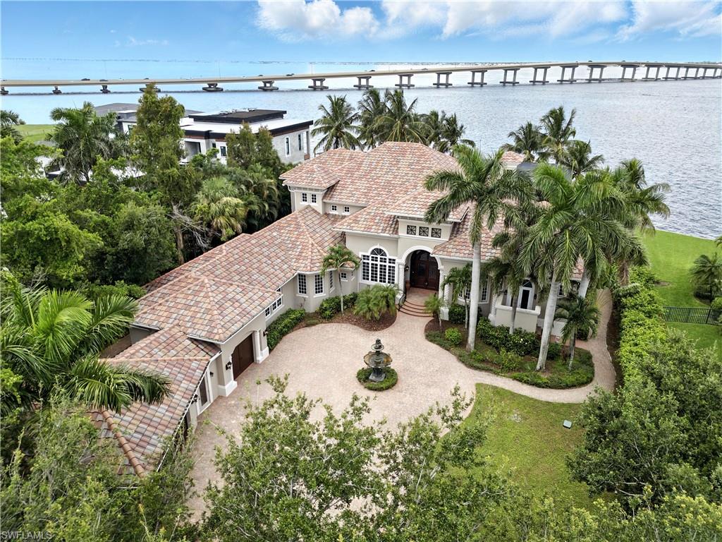 A remarkable $500,000 PRICE IMPROVEMENT now makes this Luxury Home an outstanding value.  Positioned on higher ground, the residence remained fully protected with no interior water intrusion during Hurricane Ian. Built by the 5x Pinnacle Awards winner Norm Bloxham, and one of Florida premier luxury home builders, this home is very solid and built with superior construction materials!  

 Experience the timeless elegance of Tuscan-inspired luxury on the Caloosahatchee River. This extraordinary estate offers sweeping western exposure with gorgeous sunset BREATHTAKING views over open water — the kind that leaves a lasting impression. From the moment you enter the grand foyer, you’ll be captivated by soaring cathedral ceilings, a statuesque fireplace, and a Juliet balcony that evokes the romantic charm of an Italian villa.

Every inch of this home has been designed with sophistication and warmth — far from stark modern minimalism, this residence exudes rich textures, artisanal detail, and a sense of refined comfort. Whether entertaining guests in the spacious living areas, enjoying movie nights in your private home theater, or working out in your custom-designed fitness space, this home delivers the lifestyle of your dreams.

Lower level primary master suite with jetted tub and outdoor atrium.
The upper level opens up to a game room, and two bedrooms which offer the additional master suite and huge sitting area.  Both bedrooms open to a huge balcony overlooking the water features below and a spectacular view!  

Outside, the luxury continues with a breathtaking resort-style pool and spa, framed by a stunning stone wall waterfall spilling into the spa with a serene pathway to the pool. Boaters will appreciate quick Gulf access — while enjoying the serenity of wide water views right from their backyard. 

Come see for yourself what it means to live beautifully and elegantly in Southwest Florida. This is more than a home — it’s a masterpiece of style, comfort, and unparalleled location.