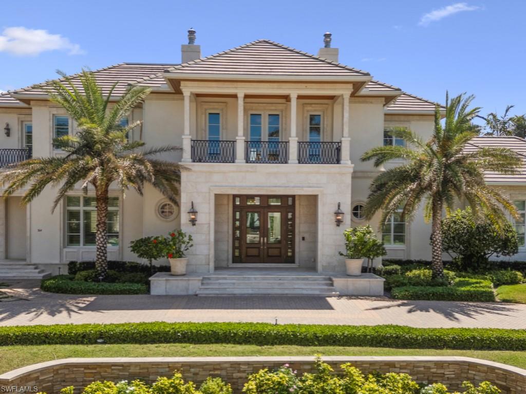 A 2013 Masterpiece nestled on a private acre-plus lot with lake views, this elegant custom home designed by Stofft Cooney Architects, built by Vincent Borelli, and with interior design and decor by Collins and Dupont, is a superb example of refined, timeless luxury. The home has every detail your heart desires, with a beautifully connected floor plan perfect for all types of entertaining, while still intimate enough to enjoy as a family home.  With many luxurious details, including intricate ceiling millwork, a temperature-controlled wine-room, walk-in wet-bar with beverage refrigerator, butler's pantry and an elevator. The home features a primary suite plus 4 guest suites plus an attached, but separate, guest retreat with a 6th bedroom and sitting room, which could be an exercise studio, mother-in-law suite or a variety of other possibilities. The exterior spaces are perfect, benefiting from the oversized lot with lake views with an outdoor kitchen and extensive lanais for relaxing and dining, all featuring motorized screens and shutters, and a gas fire-pit for relaxing on chillier evenings. The pool and spa area has a shady cabana with pool bathroom, outdoor shower and storage, and there is a Kohler whole home generator for peace of mind. Located in Flood Zone X.500 with a 12.5' elevation, the home was a safe refuge in recent storms and suffered no damage or flooding. Bay Colony is Naples' luxury living at its finest, with its private beach club renowned for elegant 5-star dining, a sparkling beach-side pool with poolside bar, extensive beach services, and is available to Bay Colony residents and guests only.