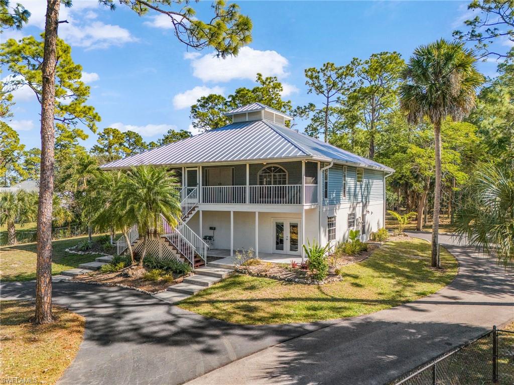 Custom-built Florida-style home tucked away in a prime close-in Golden Gate Estates location. Set on 2.5 beautifully landscaped acres, this charming property offers exceptional space, privacy, and versatility. The main residence features 3 bedrooms, 2 bathrooms, a spacious living and dining area, and an upstairs flex room ideal as an exercise room or sunroom. The first floor includes a completely separate, self-contained 2-bedroom, 2-bath guest suite with its own private entrance and no interior access to the main home—perfect for extended family, guests, or income-producing opportunities such as long-term rental or Airbnb (subject to local regulations). Pride of ownership is evident throughout. Meticulously maintained and thoughtfully upgraded the home with wood and tile flooring, granite countertops, new metal roof (2024), new pool (2021), new ACs (2023), and much more. The **oversized 3-car garage** includes an additional room ideal for an office or workshop. Outside, the property offers abundant parking, a *beautiful circular driveway*, and lush surroundings that enhance the home’s private, estate-like feel. A rare opportunity to own a spacious, well-built, and highly flexible property in one of Naples’ most desirable acreage communities.