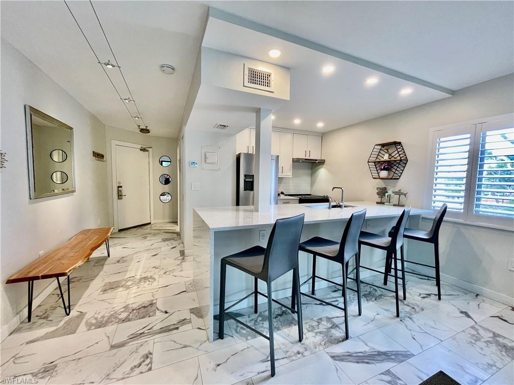 Magnificent 3210 Tennis Villas! Completely reconfigured, redesigned, and renovated. This turn-key, corner unit, 1 bedroom, 1 bathroom condo boasts only the finest detail integrated with an abundance of luxury located inside South Seas Island Resort. A floor-plan that has been redesigned to open the kitchen with just a small beam, extend the width of the island, expand the footprint of the bathroom/vanity area, and reconfigure the bedroom/closets. ONE OF A KIND! Offering a granite waterfall island, tile flooring throughout, stainless steel Whirlpool appliances, impact rated sliding glass doors, floor-to-ceiling tile walk in shower, hard-wood shaker doors, and coastal contemporary furnishings; this condo is truly hard to beat! Live the #IslandLifestyle inside the gates of South Seas Island Resort with proximity to Captiva’s white sandy beaches, the Village of Captiva, Retail Shops, Starbucks, and world-renown restaurants!