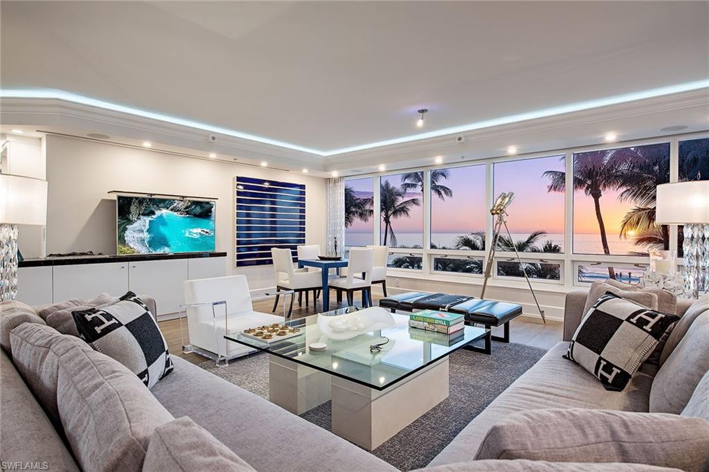 Prepare to be captivated by one of Naples exceptional and unique beachfront offerings. This completely reimagined residence lives with the comfort and privacy of a single-family home yet offers effortless convenience of luxury high-rise living. Arrive via private elevator directly into the residence, where sweeping, unobstructed Gulf views immediately set the tone. Encompassing over 6,100 square feet of air-conditioned living space, the thoughtfully designed floor plan includes three en-suite guest bedrooms, each with direct access to the expansive outdoor deck, a spacious den and an extraordinary primary suite. The primary wing offers a private office, a fireplace-accented bedroom and a lavish spa-inspired bath with an exquisite custom wardrobe. Floor-to-ceiling glass captures panoramic views of the Gulf and beach from nearly every vantage point. The chef’s kitchen is elegant and functional, featuring gas cooking, refrigerated drawers, dual dishwashers, climate-controlled wine storage and striking quartzite waterfall countertops. Just beyond the residence, and deeded to the unit, a separate guest suite provides complete independence for visitors. This fully equipped retreat includes a bedroom, bath, kitchen and living room. Seamless indoor-outdoor living defines the home, as the interiors flow effortlessly onto an extraordinary, private 5,700-plus-square-foot beachfront terrace. Exclusive to TL-2, this one-of-a-kind outdoor oasis features a heated pool/spa, summer kitchen, fire pit and generous entertaining areas, all with direct distance to the sand. Whether enjoying sunrise over the Gulf or evening sunsets along the shore, the setting is nothing short of spectacular. Completing this remarkable offering is a private lobby-accessible garage, with a lift, accommodating three vehicles, an exceptional amenity rarely found in beachfront high-rise living.