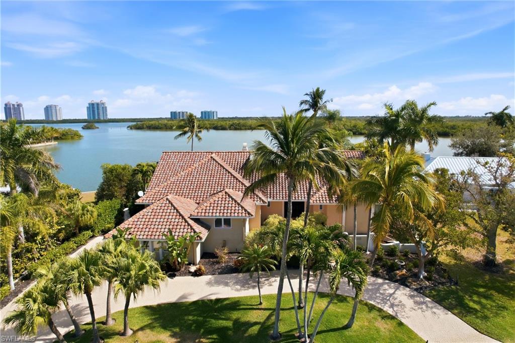 Beach & Boating Paradise on the Gulf!
This solidly constructed bayfront ranch home is built on elevated land and offers breathtaking, unobstructed bay views from every main living space. The property has never experienced water intrusion, including during Hurricane Ian and all prior storms—providing exceptional peace of mind and resilience.

Entertain with ease in the expansive living room featuring a wood-burning fireplace, dry bar, and a wall of French doors that open to stunning water views. The spacious kitchen is well-appointed with stainless steel appliances, a gas cooktop, double ovens, granite countertops, and abundant wood cabinetry.

The primary suite features beautiful wood flooring and a sitting area perfect for enjoying sunrise views over the bay. The en-suite bath includes a raised dual-sink quartz vanity, jetted tub, and separate shower.

A screened lanai spans the rear of the home, creating an ideal space for outdoor living and entertaining. The private backyard boasts a bayside heated pool with an expansive pool deck. Boaters will love the private dock just steps from the home with quick Gulf access only minutes away, while beach lovers will appreciate that Bonita Beach is just around the corner.

26876 McLaughlin Blvd. is your opportunity to own a true waterfront retreat in paradise.