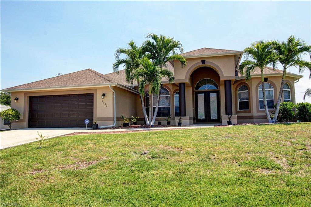 CONVENIENT LOCATION!!! The Heart Of Cape Coral-Close to Golfing, Boating, Shopping, Restaurants and A Quick Ride Into Fort Myers. Offering 3 Bedrooms 2.5 Bathrooms, Formal Dining & Living Rooms With Family Room Off Of The Kitchen, Over-Sized Garage Including A Golf Cart Door, Large Screened Patio With 1/2 Pool Bath. Tile, Carpet, Laminate Flooring With Upgraded Window Coverings Through Out. Situated On A 3 Lot Site - Floratam Sod, Fenced In Yard, Nicely Landscaped Rock Beds With Curbing. This Is A Must See!!! Call Today For Your Personal Tour !!!