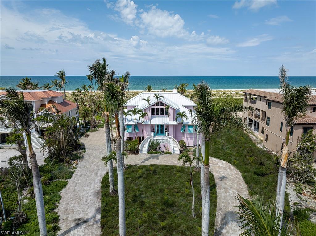 Absolutely Stunning Beach Front Home!!! Situated on an oversized beach front lot with 120' of frontage on Sanibel's most private stretch of beach, this home offers the most beautiful sunset views from nearly every room in the house! Driveway entrance is lined with gorgeous mature Royal Palm trees and the sunset views are framed with several mature leaning Coconut Palms offering the most beautiful tropical ambience. Surrounded by other luxury homes on both sides and also includes the land across the street, which is unbuildable, to offer even more privacy to this very special property. From the first moment you walk in the dramatic foyer, you will be amazed by the beach front views!! 24' ceilings in the living room featuring two stories of windows that offer plenty of natural light. Swimming pool and hot tub in the most private beach front paradise. Enjoy shelling and beach walks in your back yard and nightly sunsets from your own living room! Brand new AC units, recently remodeled and newer roof.