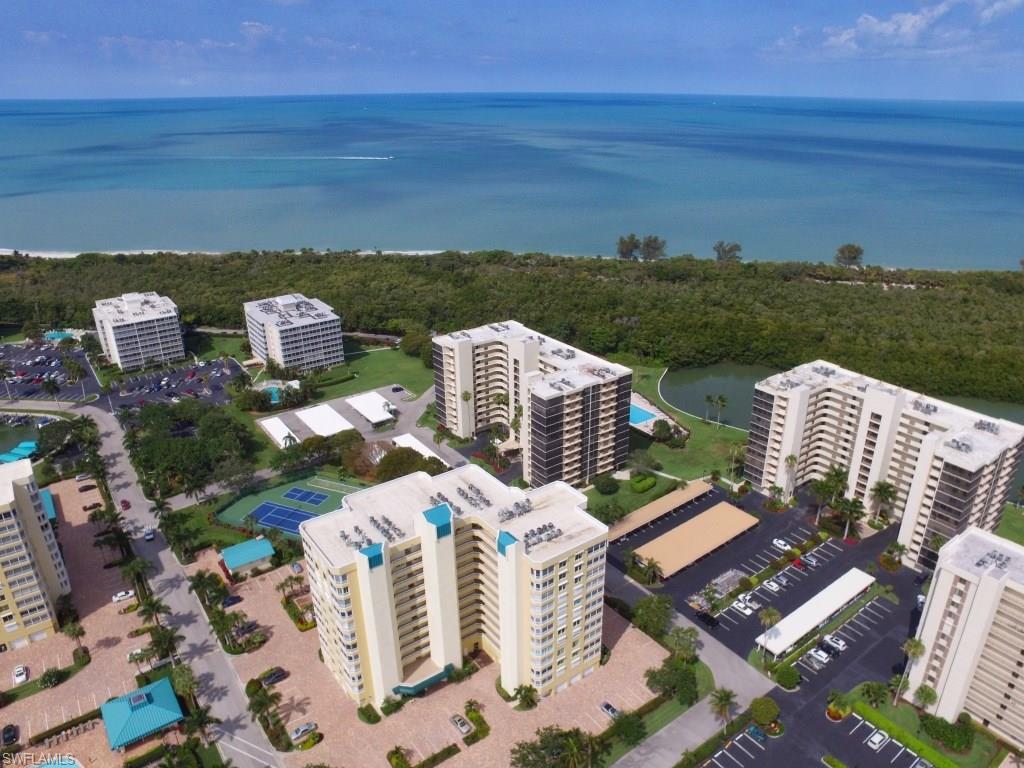 PENTHOUSE with spectacular Gulf and Bay views from every window and 9Ft sliding glass wall. Enjoy a morning coffee on your sun filled east facing lanai and finish the day with a drink on your west facing lanai watching the sun set. This well cared for unit has tile, in all traffic areas, 9 ft. ceilings (ONLY FLOOR IN BUILDING) newer cabinets, wrap around floor to ceiling sliders,  Bahama shutters, and electric hurricane shutters for peace of mind when you leave. All this plus a marina, tennis court, Bocce,  pickleball, canal side pool and covered picnic area with grill, and just a short walk to one of Naples finest beaches. This community is also only minutes from Mercato, the Ritz, the Artis and an almost endless amount of dining, shopping and entertainment options.