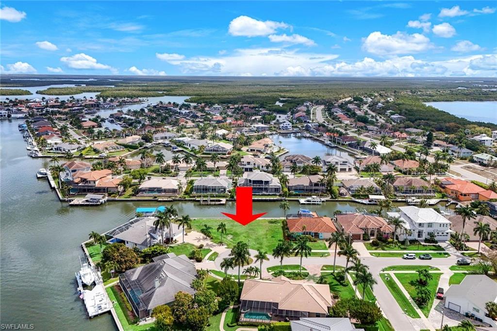 Build your dream home on this Exceptional, Waterfront Key Lot tucked away on a quiet cul-de-sac with a newer seawall (2017). Featuring 156 feet of Direct Waterfrontage, this property offers expansive views and easy access for boating, kayaking, or simply enjoying the serene surroundings. A rare opportunity to create a custom residence on an Oversized Lot at a Great Price. Close to Publix, shopping, and dining.