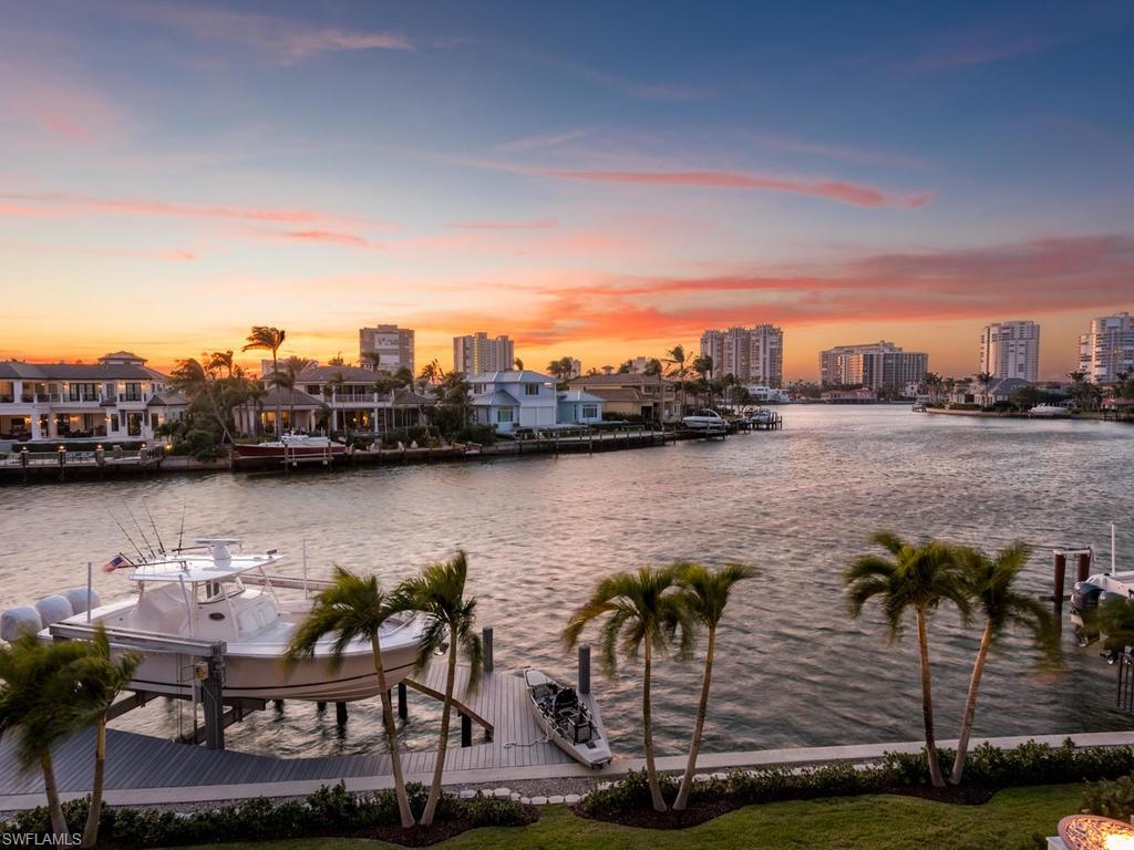 The finest example of high quality custom craftsmanship exudes from this picture perfect Park Shore residence showcasing wide open water views to the west. Solid concrete construction and poured second floor along with whole house generator providing peace of mind. Soaring ceilings and the open floor plan perfectly frame the vistas of Venetian Bay and awe inspiring sunsets. State of the art features and finishes provide A/V systems, Sonos, cameras, exotic stones, custom marble baths, master sauna, and other luxurious selections. Wolf and Sub Zero, double ovens, Asko dual dishwashers, and option of induction or gas cooking in the kitchen. Wide oak wood floors throughout and Calacatta Gold Premium slabs draped over the island. Sensational outdoor living is achieved with rare marble decking, outdoor shower, pool bath, expansive covered entertaining areas, Wolf summer kitchen, and shutter systems for protection while away. The new sea wall, dock and boat lift make it ideal for entertaining and a quick boat ride to the Gulf. Location close to Venetian Village and the resident only private beach park.