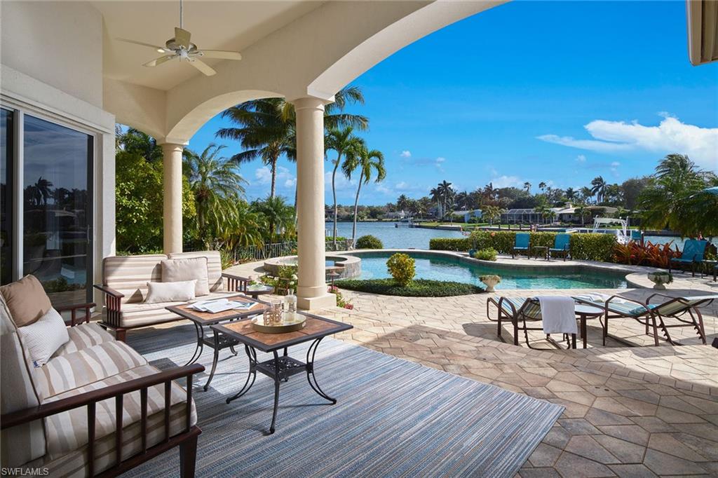 Sparkling southern bay views are the focal point of this well-designed four-bedroom home situated on the quiet Spring Line Drive in the Moorings. With over 120 feet of water frontage and an expansive pool area and dock, you will be spending all of your time outside. Zero-corner sliders in the recently refreshed family room bring the outside in and coupled with the mitered glass in the morning room, provide light and a stunning view from the open kitchen. Over 3,000 square feet sprawls on the first floor providing residents an easy flowing floor plan while also providing privacy for guests. A new roof added in 2020, 3-car garage, storm shutters throughout and a gorgeous view, this opportunity will not last long. Residents are also eligible to join the voluntary Moorings Beach Association.