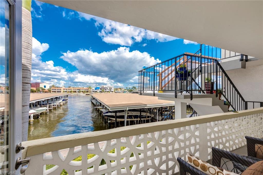 $10,000 price improvement! Updated End-Unit checks all the must-have boxes: Waterfront with incredible Naples Bay & Boating views; Walking distance to 5th Avenue, and a Deeded Covered Boat Slip w/ Electric Lift - accommodates a 26' boat. Open concept floor plan features bamboo flooring, stainless appliances, granite counters, new hurricane windows, crown molding and dual Master Suites with large walk-in closets and renovated full baths with more gorgeous granite. Other features include front loading, in-unit washer/dryer, Maestro Dimmers, plantation shutters, new NEST thermostat, convection-micro, LED lighting, closet systems, boat slip weights/pulleys/straps. Easily accessible by elevator. The Marina Manor community has a New Board of Directors and has just renovated the community pool; more community updates coming first half of 2018 incl new railings, boat dock roofs, and other general improvements - all paid for. The upcoming renovation of nearby Cambier Park, and "TRIO", the new 9-story development at 5th Ave South & Davis Blvd w/ restaurants, specialty shops, and residences, all make the location of this Condo even more desirable. (SORRY NO PETS)