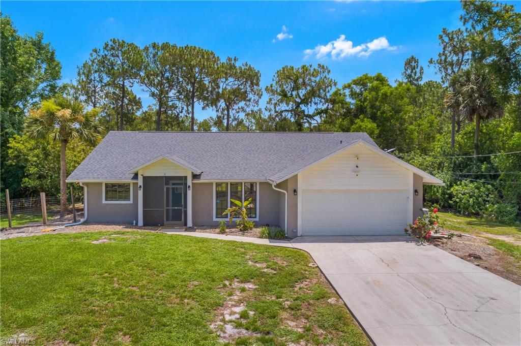 Welcome to 2.27 acres of paradise, where privacy, space, and endless possibilities come together just minutes from everything Naples has to offer. This beautifully maintained property features a 3-bedroom, 2-bathroom main residence with a 2-car garage. Inside, the kitchen is equipped with stainless steel appliances, granite countertops, and a tile backsplash, while the spacious primary suite offers a walk-in closet, dual vanities, and a luxurious walk-in shower with multiple shower heads. A large screened lanai provides ample covered outdoor living space, and a portion of the backyard is fenced for added convenience. A standout feature is the permitted 1,200-square-foot metal building, engineered to withstand 180 mph winds, offering exceptional flexibility for enclosed parking of additional vehicles, boats, ATVs, trailers, or recreational equipment. It also makes an ideal workshop, mechanic's garage, or hobby space, keeping noise, dust, and fumes separate from the home. With its size and versatility, it could even be converted into a private in-law suite or additional living quarters. Additional improvements include a water softener system, reverse osmosis at the kitchen sink, gutters, a new roof (2024), hot water heater (2025), A/C (2014), and a freshly painted inside (2026). Enjoy the rare combination of expansive acreage and peaceful country living while being only 5 to 10 minutes from the shopping, dining, entertainment, and everyday conveniences that Naples is known for.