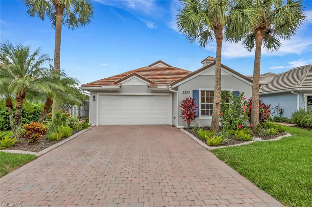 Welcome to 2232 Summersweet Drive in Cascades at River Hall. This home showcases a bright design accented by tile flooring throughout. Roof was replaced in 2022. The dining area has been enhanced with custom updated cabinetry, adding valuable storage space. A professionally added fireplace serves as a stunning focal point in the main living area, creating a warm and inviting atmosphere ideal for everyday living and entertaining alike. Outdoor living is equally impressive, featuring an expansive rear patio that provides space for hosting guests, enjoying morning coffee, or relaxing while taking in the peaceful surroundings. The garage has been upgraded with a newly installed epoxy floor, delivering a clean, polished finish and long lasting durability. Located within the highly desirable Cascades at River Hall, residents enjoy a vibrant lifestyle with access to premier amenities, beautifully maintained grounds, and convenient proximity to shopping, dining, golf courses, and Southwest Florida's most popular destinations. This move in ready home offers a perfect blend of comfort, functionality, and quality upgrades in one of the area's most sought after communities.