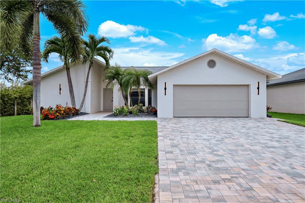 Step into luxury with this completely remodeled 3-bedroom, 2-bathroom pool home, offered fully furnished and ready for immediate resort-style living as your ultimate vacation getaway or dream forever home. The property greets you with exceptional curb appeal featuring a brand-new roof and a freshly completed paver driveway. Inside, you'll find continuous wood-look tile flooring, designer light fixtures, and a light-filled open-concept layout anchored by a chef-inspired kitchen complete with an upgraded appliance package and a custom mini bar with a wine cooler. Off the primary suite, a versatile home office features built-in desk space and its own private outdoor entry door. Both bathrooms feature fully updated showers with new tile and upgraded vanities. Outside, your private backyard paradise boasts an expansive new paver deck surrounding a fully renovated pool. Hot tub included. All located just moments from Camelot Park for tennis and pickleball, and within walking distance of vibrant Cape Harbour, where you can dine, shop, or rent a boat for the day!