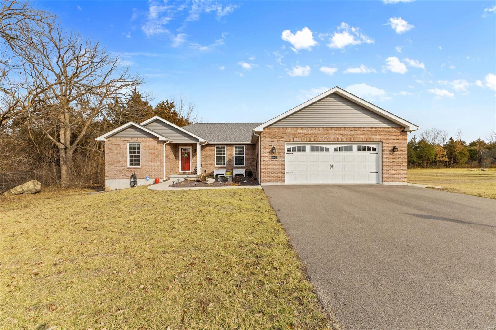 Explore this inviting 3-bed, 2-bath brick residence tucked away in a cul-de-sac. This 3 year-old home has over 1800 square feet of living space. A spacious open floor plan and a kitchen with a large center island and granite countertops. Enjoy the expansive deck overlooking the fenced in yard sitting on just over an acre of land in town! This home effortlessly combines classic charm with modern comfort in a serene setting.