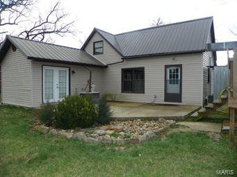 Do you want a little acreage?  Need some space from the neighbors?  Take a look at this 3 Bedroom 1 Bathroom home on 10.02 acres!  This farm style house has been very well kept!  New floors throughout house!  Kitchens has been updated!  Metal Roof!!  The outside has so many perks!  Patio off the Master Bedroom!!!  Deck with above ground pool!!  Storm Shelter!  Chicken Coup!  2 outbuildings!  Detached garage with storage area/shop area!!  Cross fencing!!  POND!!!  All this and its at the end of the road!  Don't miss out come and see this home today!!
