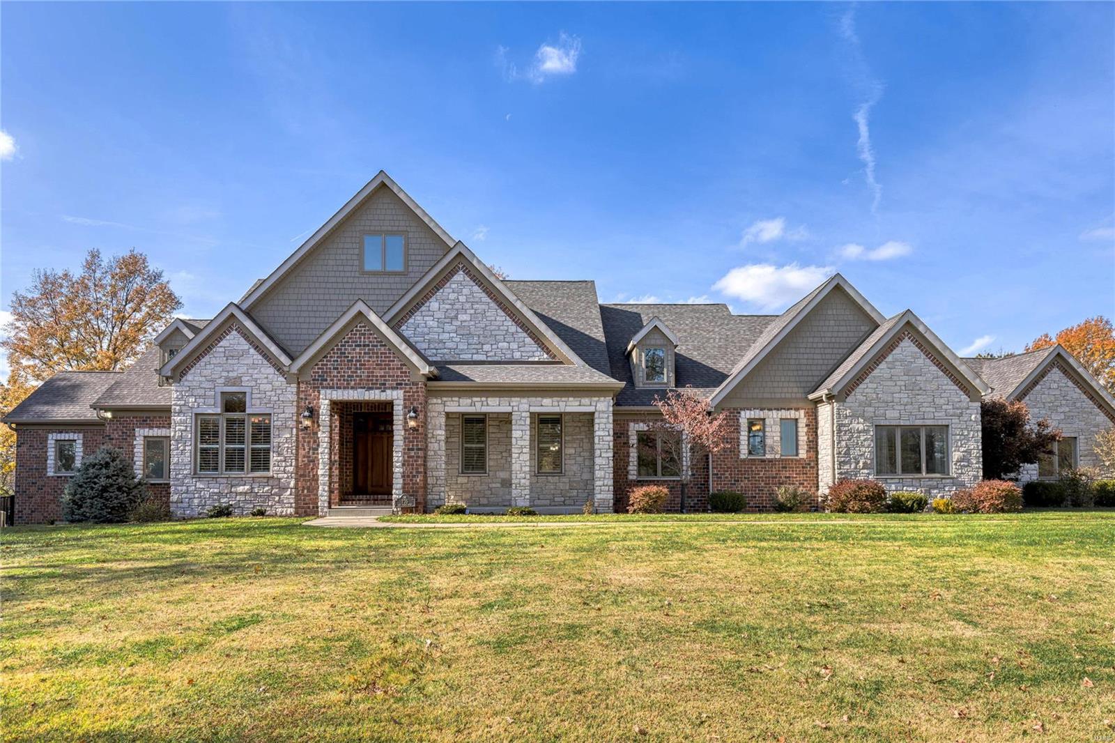 Spectacular one of a kind opportunity to own this Estate on 7.5 acres in the heart of West County. This breathtaking estate has been in the family for over 75 years and is now available. As you walk through the front door of this custom home, you will notice the impressive millwork, hand scraped wood floors and a log feature wall, from the original log cabin on this property. Cozy up and enjoy a fire in the massive floor to ceiling stone fireplace or step into the impressive kitchen with high end appliances, butlers pantry, and office nook. The lower level highlights additional custom work with a with a gathering bar, game room, fireplace, and two additional bedrooms. On the airy screened in porch you will find custom masonry floor and stone fireplace.Enjoy the spectacular and private tree line view that backs to Missouri Department of Conservation land. This impressive home boasts a free form saltwater heated pool, and a separate building for additional vehicles and a workshop. Additional Rooms: Mud Room