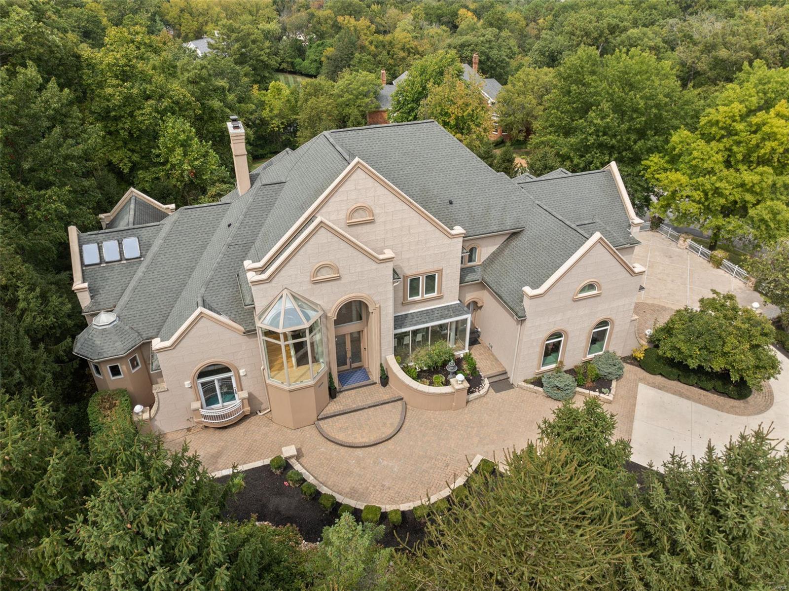 Substantial price adjustment! Now listed at an exceptional value, this home represents luxury living at a significantly reduced price. Take advantage of this rare opportunity. Be prepared to be blown away by modern luxury on a very private cul-de-sac of only 3 homes in prestigious Town and Country. The epitome of luxury living, this floorplan boasts 6 bedrooms, 10 bathrooms, and over 9,500 sqft of refined living space. Hallmarks are an open concept with abundant glass and skylights. Enjoy a two-story great room capturing outstanding views - a two-story water feature with a 2nd stairwell servicing all levels wrapped around a pillar of cascading water. The upper level has 4 bedrooms, all en-suite. The above grade walk-out lower level features media and game rooms, an additional sleeping area, and home office, as well as 2 full baths. Every detail has been meticulously crafted to elevate your lifestyle. Steps away from Longview Farm Park and Masonridge Elementary school.