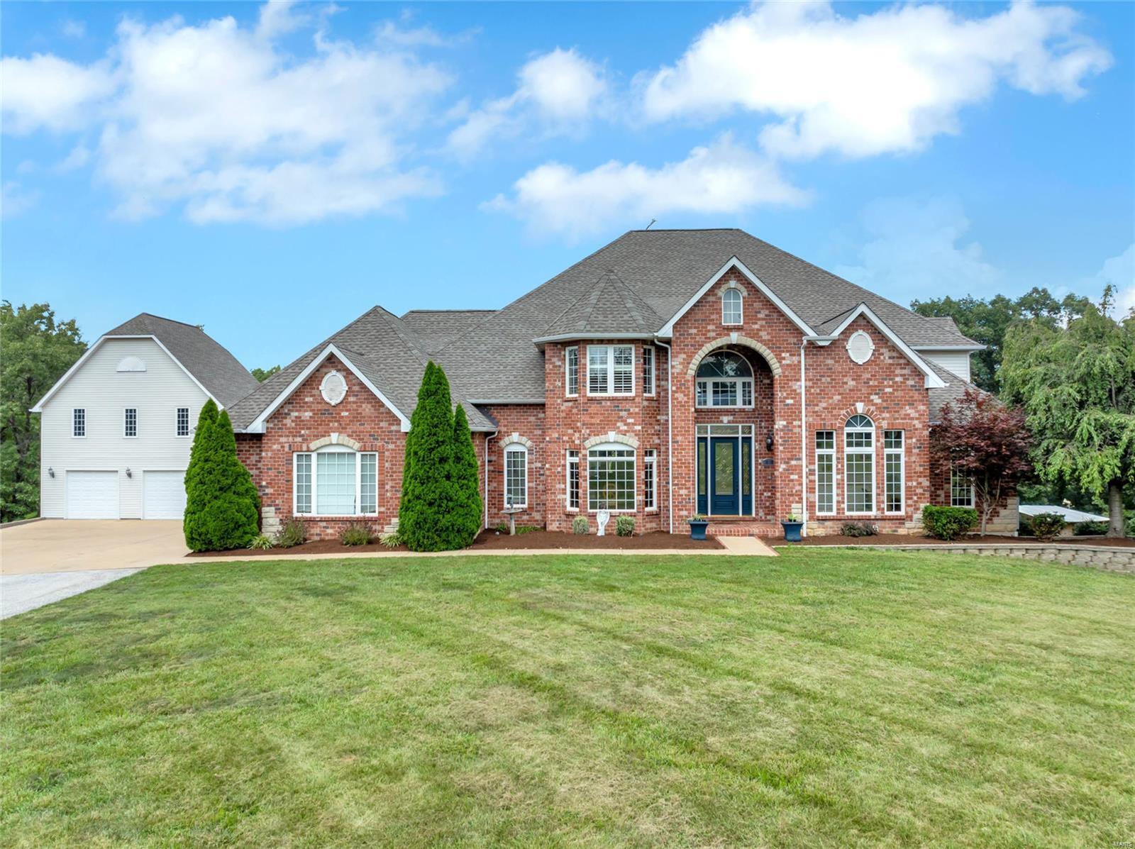 Looking for a lifestyle of peace & tranquility? Look no further. Introducing this magnificent 1.5 story Atrium home with over 7000 square foot of divine living space nestled on 31 acres in Seckman School District. The gourmet kitchen/hearth room offers full overlay cabinetry, gas cook top, separate oven, built in side-by-side refrigerator, solid surface counter tops, ice maker, beverage center. The primary suite includes a separate whirlpool tub, a double walk-in shower, & a private deck overlooking the inviting inground swimming pool. The incredible walk out LL boasts a rec room, full bath, exercise room, kitchen, & a fabulous theatre. Other interior features include 4 gas fireplaces, zoned HVAC, Italian marble flooring, security system, & a bright and airy sunroom off of the kitchen. This impressive Estate boasts a 25x30 detached carriage house that includes its own electric panel, septic system, and a plumbing rough in. The 60x30 pole barn is the perfect place for workshop/man cave. Additional Rooms: Sun Room