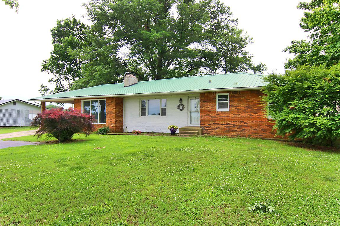 Brick Ranch, three bedrooms, one bath, living room, family room, and large kitchen. Fenced backyard with two storage buildings. Basement and carport.