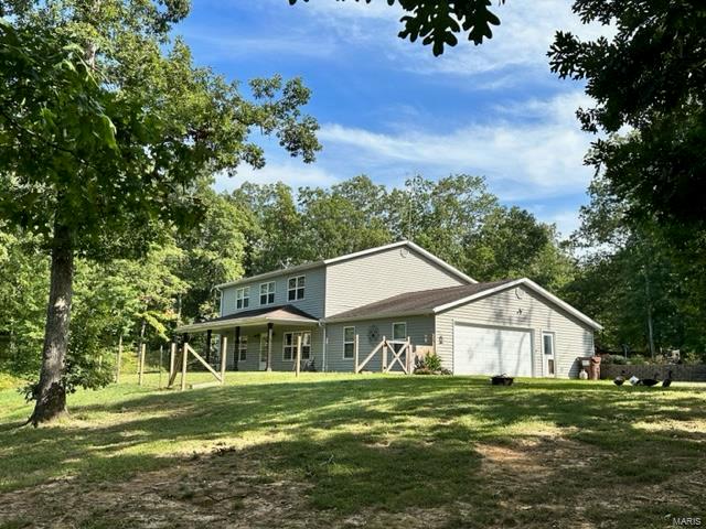 If interested in house, shop and 61.39 acres can be purchased for $475,000. Hunt, fish and swim right on your own your own property. Country living only 20 minutes from Jackson. 2640 sq ft home w/4 bedrooms, 2.5 bathrooms, 2 car garage sitting on 11.39 acres. 30x40 shop has a full bathroom, kitchen, heat and its own water heater. Above ground pool is 24x24 and sits off the back of the new 28x25 deck. Enjoy fishing right out your front door in the .70 acres stocked pond or riding your ATV through the trails. New carpet and paint was installed in 2 upstairs bedrooms, new engineered wood flooring was installed in the master bedroom, new water heater less than a year old, new pool sand filter, and a new deck, leaving nothing for you to do but move in. Enjoy the peace and quite while still being conveniently located from town. An additional 50 acres of wooded property can be purchased. Seller is a licensed Missouri REALTOR. Price increased to include the full 61.39 acres, house and shop.