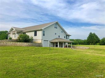 IF YOU ARE SEARCHING FOR PRIVACY WITH A VIEW, PRIVATE LAKE AND A BEAUTIFUL HOME ON ACREAGE....THIS IS IT !!  THIS GREAT PROPERTY IS SITUATED 13.5 ACRES AND OFFERS 5 BEDROOMS, 4 FULL BATHS, VERY OPEN FLOOR PLAN, MOSTLY HARDWOOD & TILE FLOORS, LARGE KITCHEN W/GRANITE COUNTERS, DINING AREA, LIVING ROOM, AND THE SUNROOM WITH AMAZING  VIEWS OF THE LAND & LAKE. THE MAIN LEVEL OFFERS 3 BEDROOMS, 2 BATHS, KITCHEN, LIVING ROOM, LAUNDRY ROOM, THE DINING AREA AND SUNROOM HAS ACCESS TO THE LARGE REAR DECK PERFECT FOR ENTERTAINING.  MAIN LEVEL LAUNDRY ROOM. PARTIAL BASEMENT- LOWER LEVEL HAS A FAMILY ROOM, KITCHEN, LAUNDRY ROOM #2,  FULL BATH # 3. THE PERFECT SET UP FOR EXTENDED GUESTS OR FAMILY. THE BONUS AREA OVER THE GARAGE W/ BEDROOM #5, FULL BATH #4. THIS AREA HAS ITS OWN HVAC SYSTEM, ALLOWING USE ONLY AS NEEDED. 3850 SQ FT ML OF LIVING SPACE. 2 CAR ATTACHED GARAGE. THIS HOME WAS BUILT WITH A PERSON IN NEED OF HANDICAP FEATURES AND WHEEL CHAIR ASSESSABLE.
CONVENIENTLY LOCATED CLOSE TO TOWN.