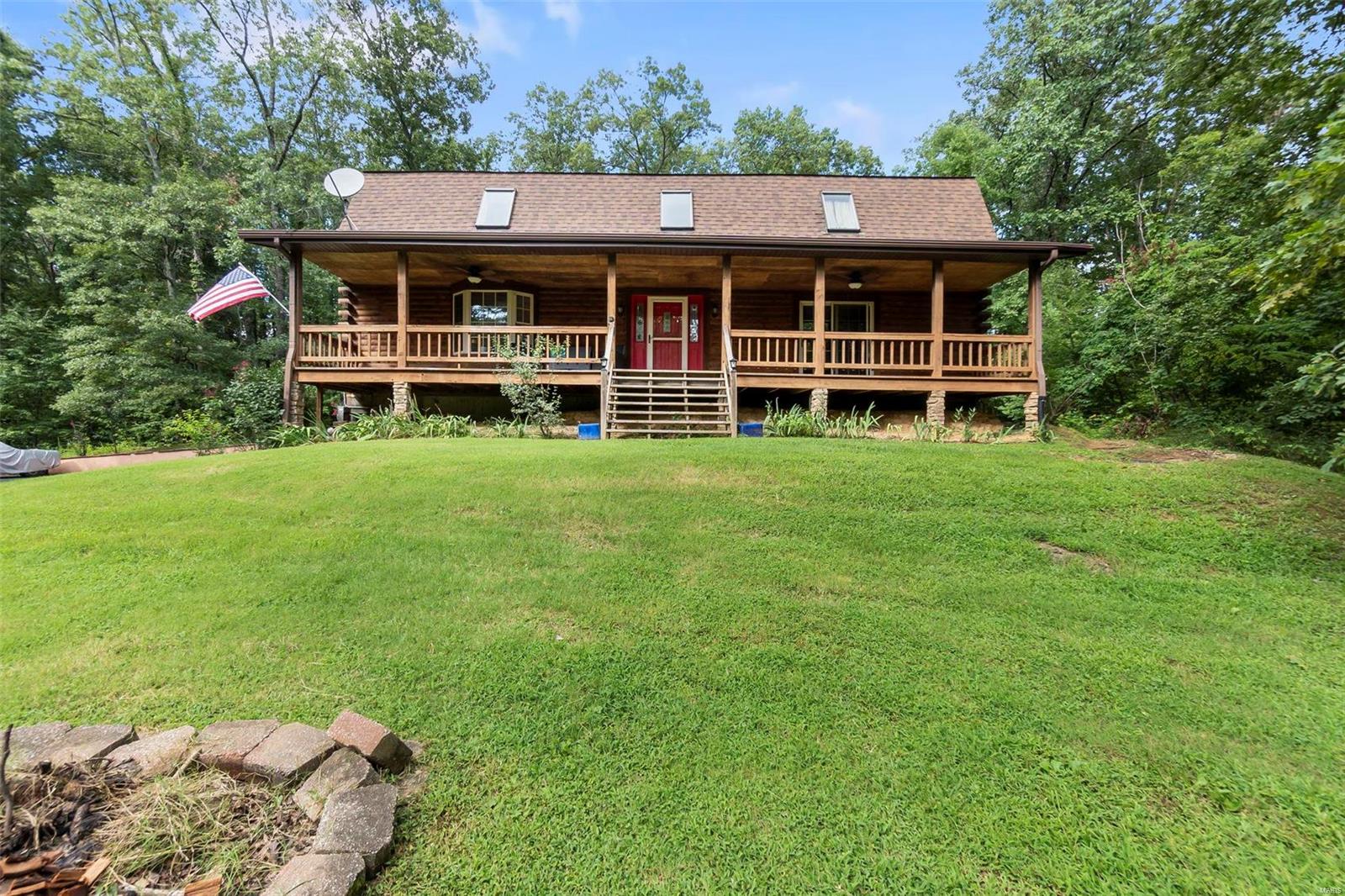 Located in North Hills Estates you'll find this truly unique home tucked away in a dream like forest. Watch the changing seasons around you from the comfort of your covered front or back porch! Constructed with a Gambrel style roof upon entering the home you will notice soaring ceilings and natural lighting on all sides. The kitchen cabinets & island were all professionally painted locally by Refurbished Forest & are paired with beautiful granite countertops plus your laundry room / walk in pantry. The open concept living room is perfect for entertaining, showcasing a floor to ceiling gas fireplace. Upstairs is a balcony hangout spot overlooking the main level, plus two bedrooms and a bathroom. The main level master bedroom walks out to the front porch and also has a private ensuite soaking tub and separate shower. In the walkout basement are two bonus rooms , a bathroom, and a large Recreational room with Vinyl flooring. Outside is a pool, shed, and abundance of forest for exploring!