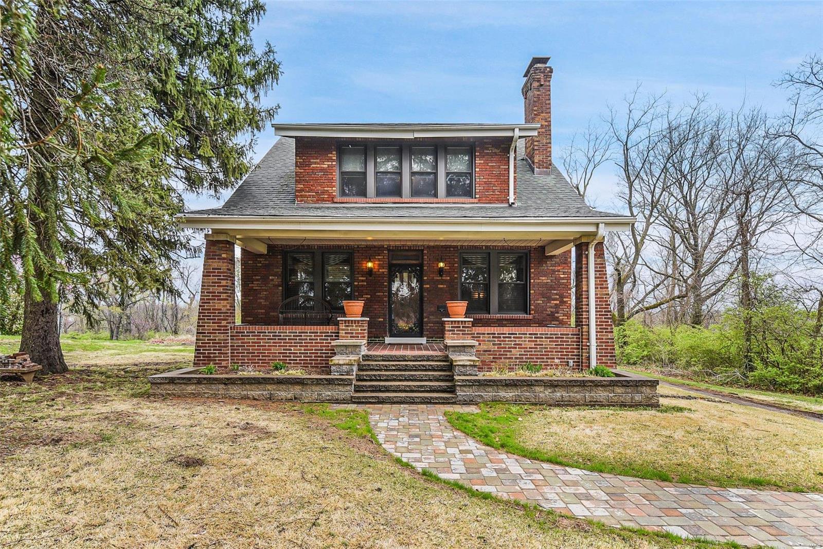Brand new Septic System!! Welcome home to this BEAUTIFUL, ALL BRICK 2 story home situated on 3 acres with many ORIGINAL features! You will LOVE the original HARDWOOD FLOORS, SOLID WOOD DOORS, CROWN MOLDING & 9ft ceilings throughout the main level! The large living room has original STAINED GLASS WINDOWS, wood cased windows and a W/B fireplace with wood mantle! Head through the FRENCH DOORS to the dining room and BEAUTIFUL COFFERED CEILING! The kitchen has ARCHED DOORWAYS, a butler’s pantry, CUSTOM CHERRY CABINETS and ORIGINAL VITROLITE TILE! Head up the T STAIRCASE to your LARGE MASTER BEDROOM with his/hers closets! The bathroom has BASKET WOVEN TILE FLOORS, a pedestal sink and an UPDATED BATHTUB with SHOWER! 2 add’l bedrooms and a LARGE WALK IN CLOSET complete the upper level! The walkout lower level is perfect for a workshop and storage. The new boiler was recently installed! The exterior features a COVERED FRONT PORCH, a DETACHED 2 CAR GARAGE and a concrete porch off of the kitchen!