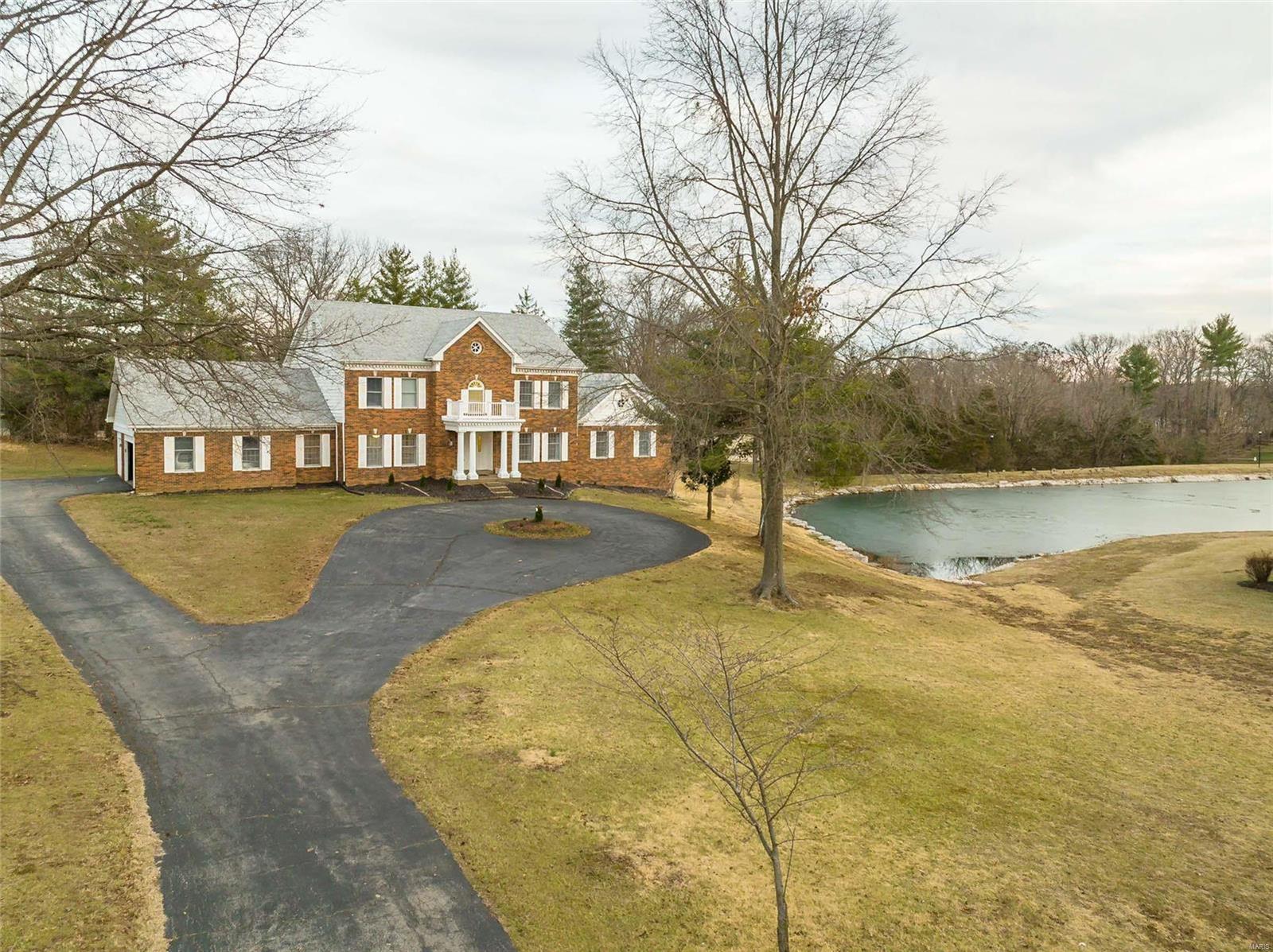 Spectacular lakefront Georgian Colonial in premier Town & Country neighborhood. this custom-built 1.5 Sty features exceptional craftmanship & distinctive architectural elements throughout including oak hardwoods, detailed trim work & Palladian windows. 2-Sty marble foyer leads to formal living room, coffered dining room & step-down family room with wet bar, brick fireplace & French doors taht open to deck & patio. Chef's kitchen with granite countertops, white cabinetry & 7' center island adjoins private office & light-filled breakfast room with convenient planning center. Spacious master bedroom suite with marble bath offers an appealing retreat. Front & rear staircases access 4 additional bedrooms & 2 full baths. Walk-out Lower Level includes recreation room with brick fireplace & 12' wet bar, game room, office & full bath. Situated on a .86-acre cul-de-sac lot with deck, patio & 3-car garage. Queeny Park, Longview Farm Park & Mason Village shops & restaurants are just minutes away.