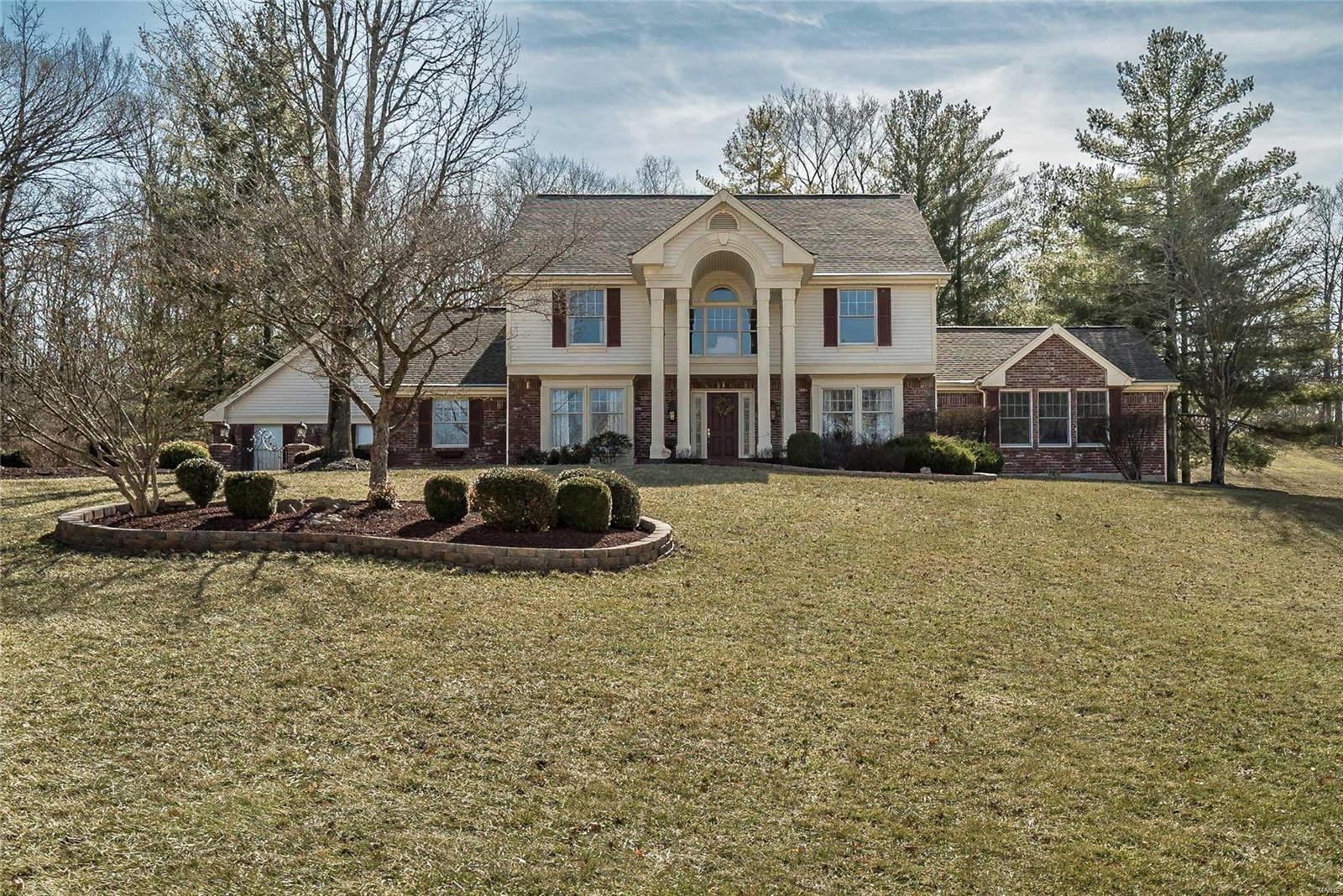 This beautifully appointed 1.5 story home offers gleaming hardwood floors flowing into the dining room, kitchen/breakfast room and office. The updated kitchen offers a huge center island, custom cabinets, walk-in pantry, planning desk & granite counters. The light & bright breakfast area has a gas fireplace & walks out to a charming gated patio. A unique bar between the kitchen & 2 story greatroom is perfect for entertaining & family gatherings. The great room is warm & bright with a wall of windows & gas fireplace.  The main level master suite is truly a sanctuary w/vaulted ceilings in both bedroom & bathroom, gorgeous finishes in updated bath & walks out to a screened-in porch.  The outdoor area is a tranquil escape with spectacular landscaping and privacy. Upstairs find a loft area, 3 spacious bedrooms and another updated bathroom.  The basement is super clean, has a rough-in and is awaiting your finishes. The utmost in quality is in this lovely home that is awaiting its new owners!