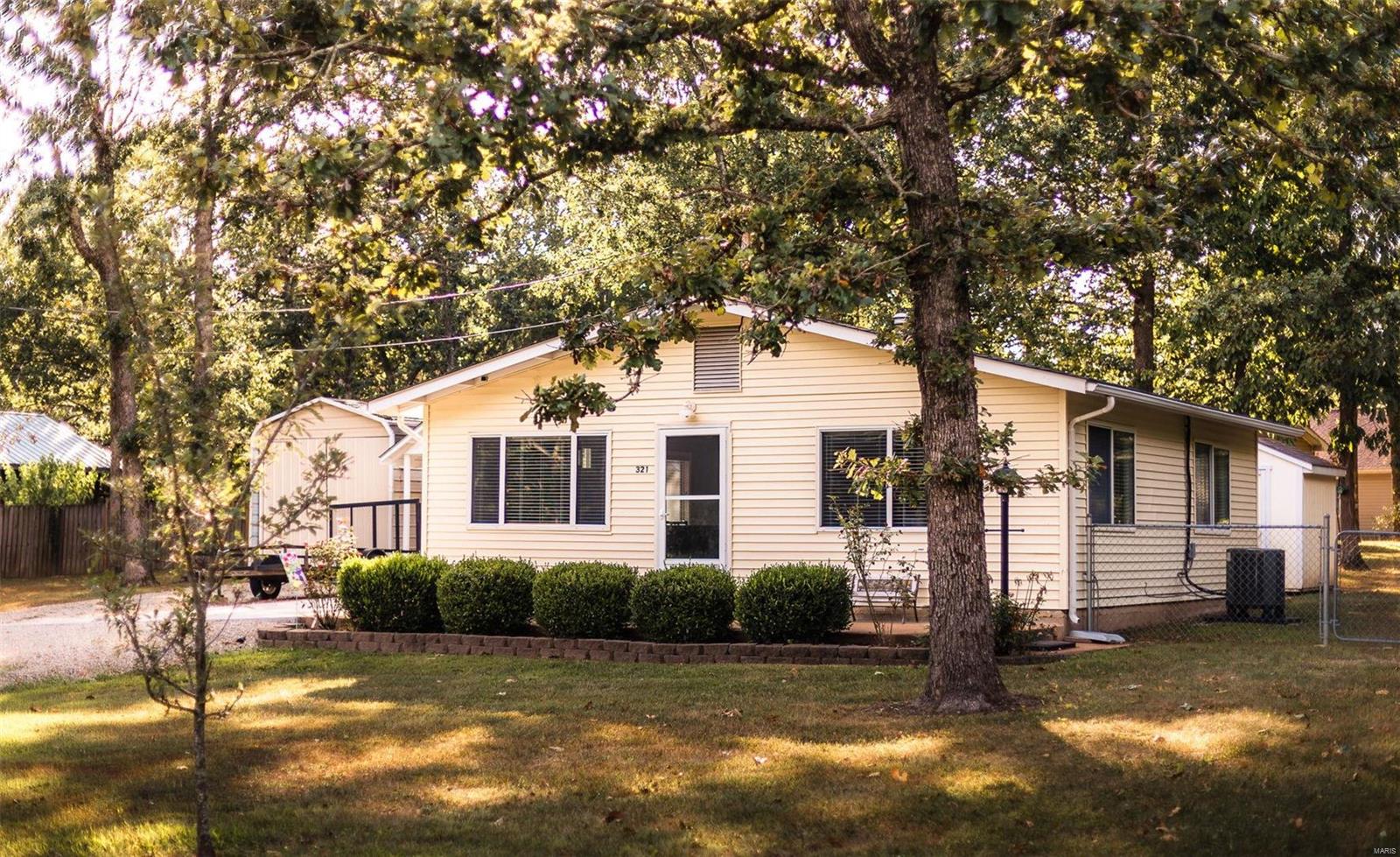 This adorable home is light and bright. Situated on a double lot, you have lots of privacy. A large storage shed accommodates your boat, golf cart, ATV, etc. Partially fenced yard great for pets or children. One concrete parking pad. Inside, you'll find two bedrooms. One is large enough for King sized bed. Start enjoying lake life on this 326 acre lake. Boating, swimming, fishing are all available to you and your guests. Tennis courts, basket ball courts, horseshoes and a sandy beach swimming area are also amenities currently offered by the community. There is a community center available to rent and a full service marina for all your boating needs.