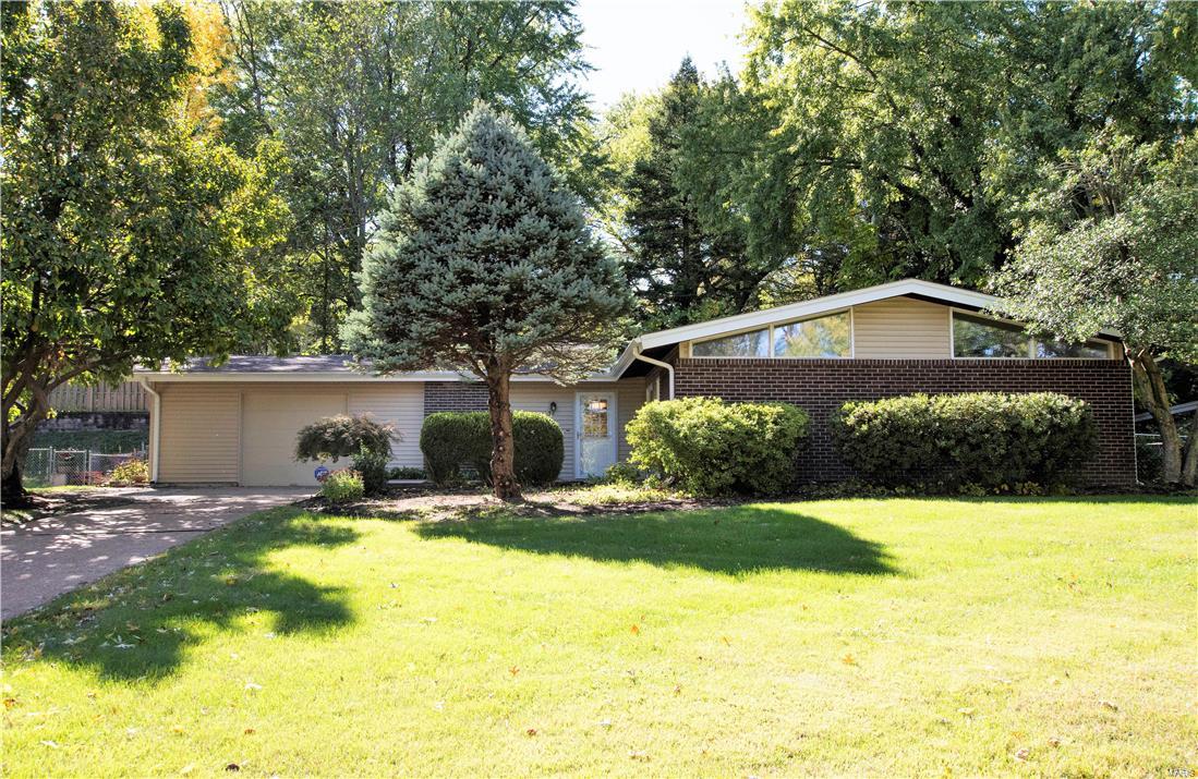 Adorable 3 bed/2 Bath 1,500 SF ranch with comfortable, open floor plan. Enter the family room and notice vaulted ceilings with stylish indirect lighting, adding dimension to the space, wood burning fireplace, and natural wood floors throughout. Two sets of over-sized sliding doors fill the rear of the home, bringing in the greenery of the outdoors. The bright kitchen offers white cabinets with new hardware and ceramic tile floors. Entertain with ease in the large separate dining room. Hardwood floors, 6-panel doors, and neutral paint throughout. The main and master baths have tub and shower, updated vanity, hardware, and lighting. Main floor laundry! The low maintenance fenced yard with covered patio adds just the right amount of outdoor living and entertainment space. Extra long one car garage and utility shed offer ample storage. New roof, gutters, siding in 2012. Passed County Inspection. Located near Page Ave. and I-270, easy access to hwys, shopping, dining. Pattonville Schools.