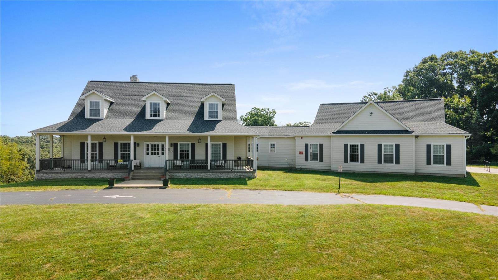 This magnificent house sits on almost 15 acres of beautiful land.  The expansive property offers a private setting allowing for stunning views.  The residence features 3520 sq ft with over 5000 sq ft of total living area that caters to a variety of living arrangements.  The main level has soaring 10 ft ceilings, two bedrooms, a large kitchen, great room with a stone fireplace and an eating area with three walls of windows.  The lower level walk out is also accessible from a wide sidewalk with handrail and is highlighted by a bedroom, rec room and additional stone fireplace.  The outdoor living is equally impressive with a large covered porch and deck that invite you to relax and enjoy the peaceful surroundings.  THere is also paved parking for up to 10 cars.